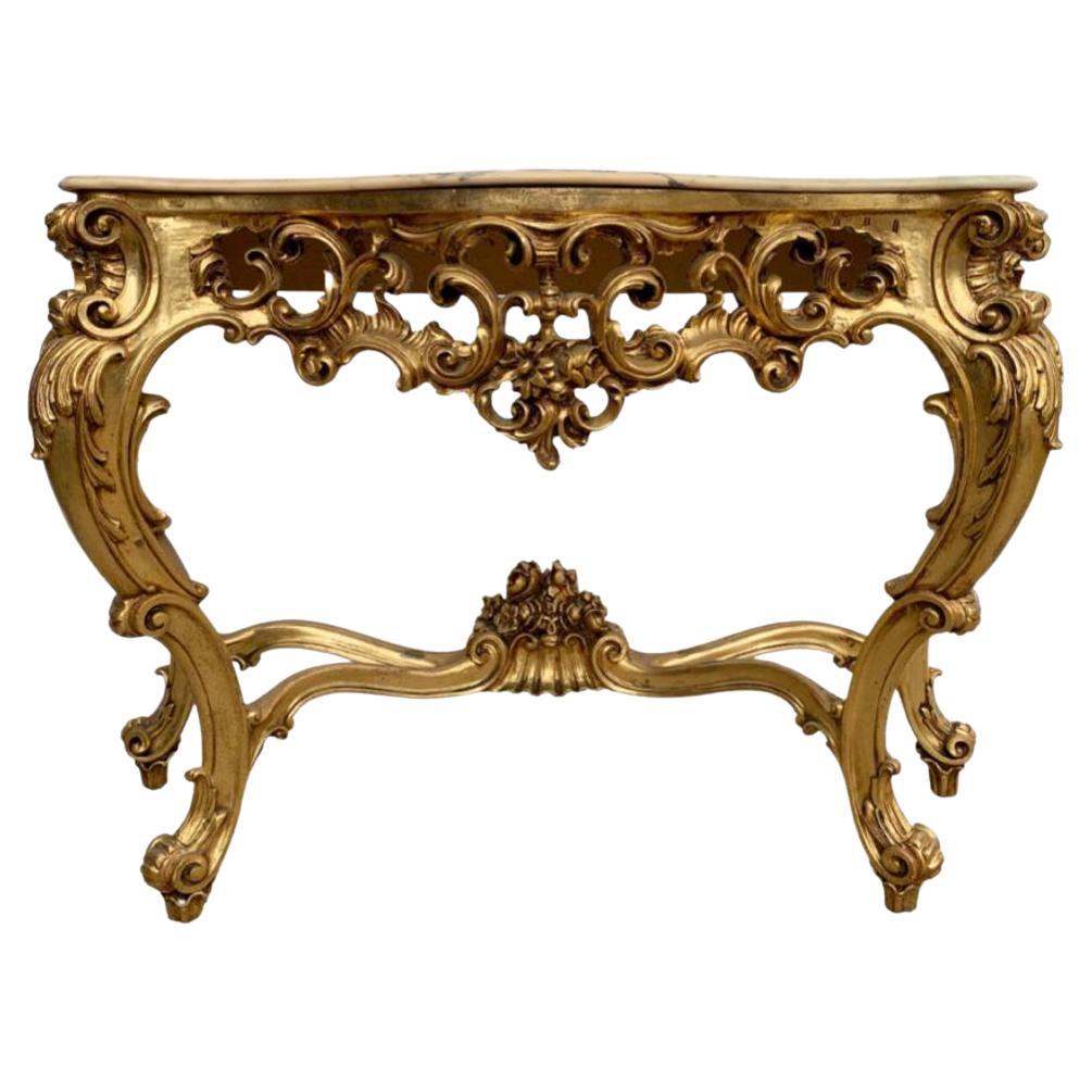 Table console vintage en bois doré fortement sculpté de style Louis XIV