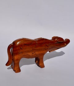 An african solid wood puzzle in the shape of a cow