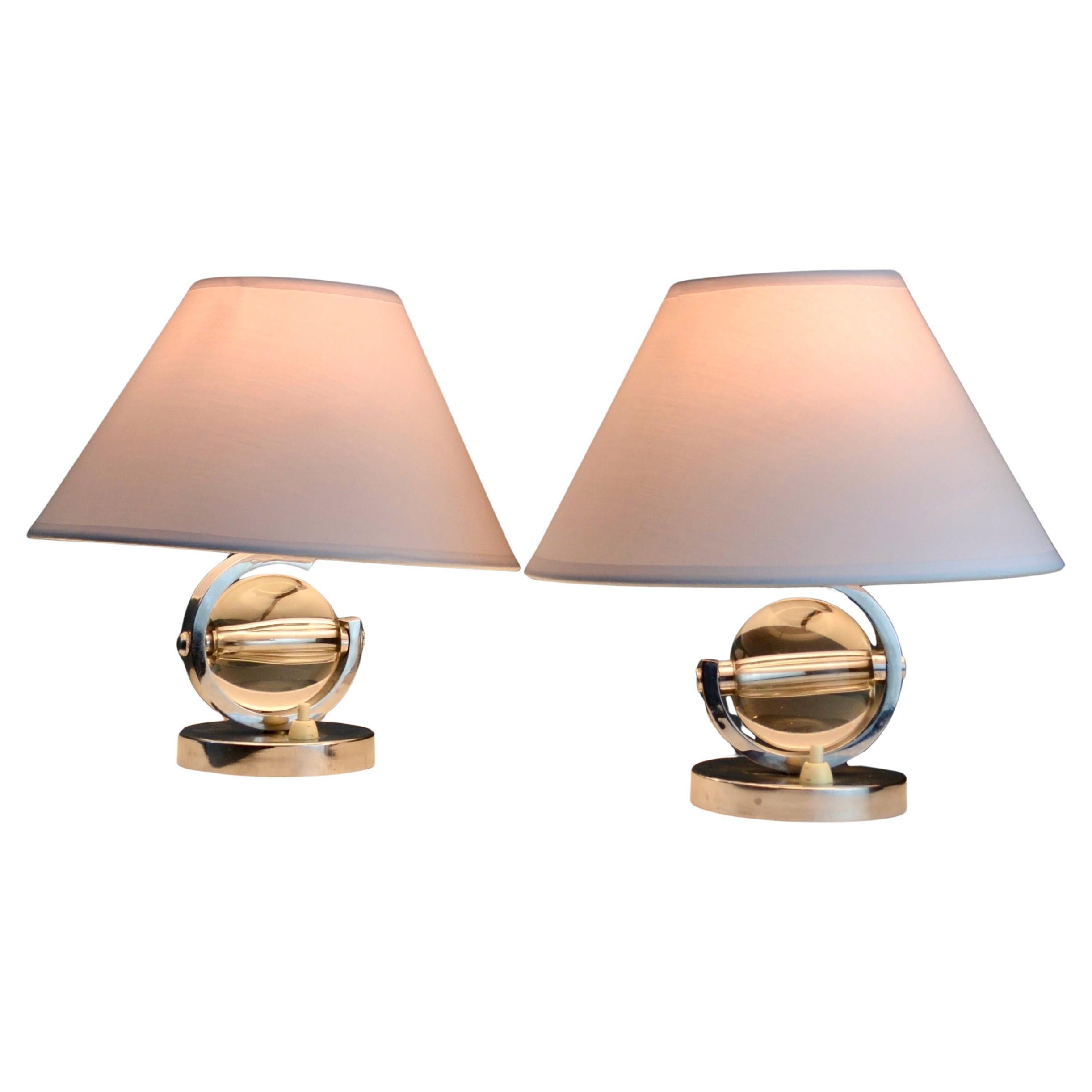 Elegant and timeless, this pair of Art Deco lamps evokes the distinctive style of Jacques Adnet. Perfect for adding a touch of sophistication to any interior, these lamps harmoniously combine luxurious materials such as nickel-plated steel and
