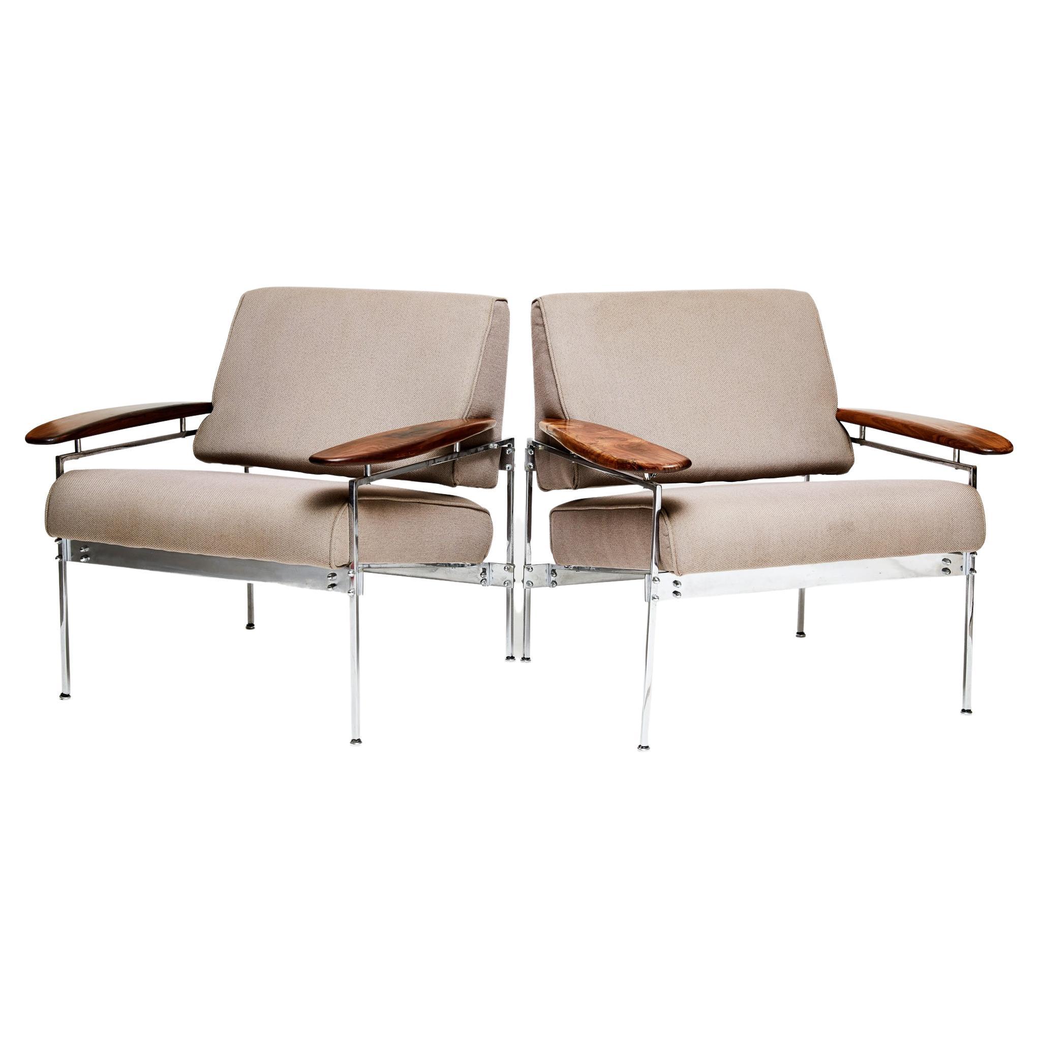 Available today, the Brazilian Modern armchairs feature a chrome steel frame, beige fabric, and jacaranda hardwood (Brazilian rosewood) armrests. The armchair is a merge of sleek modernist elements and warm robust qualities. The armrests in