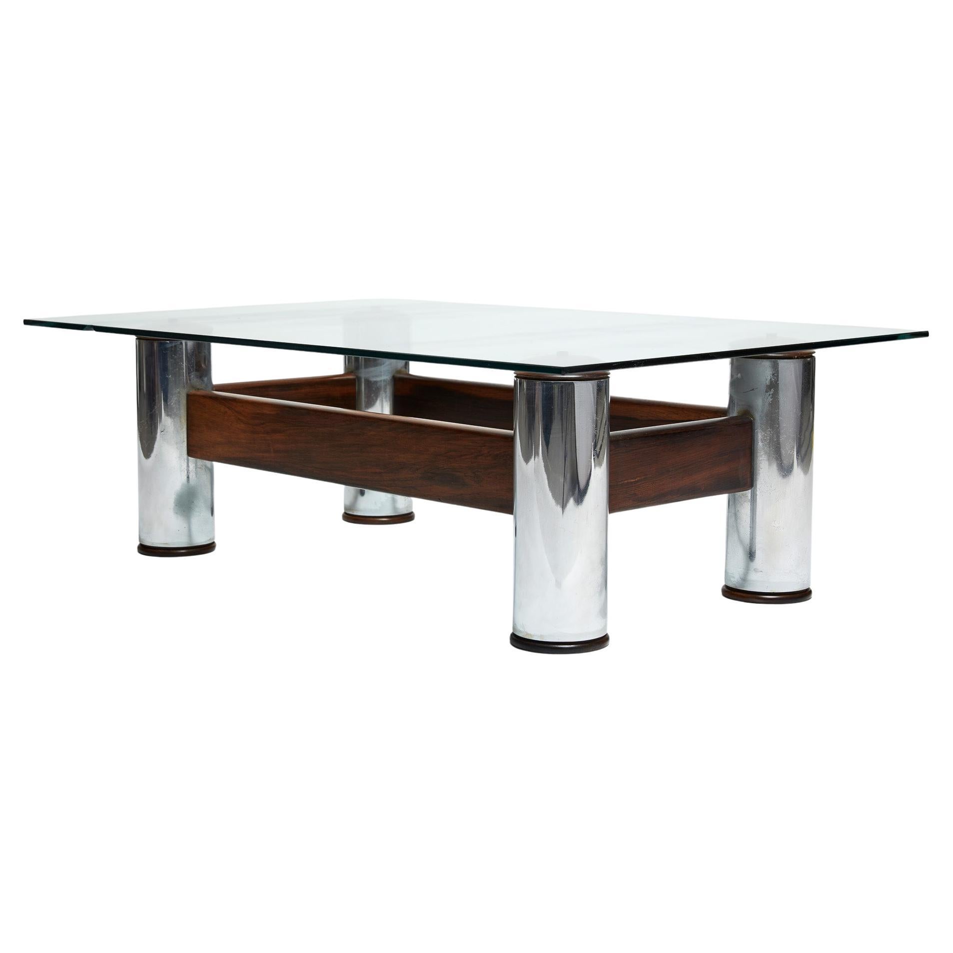 The “Amelia” coffee table has chrome-plated brass tube feet, solid jacaranda (Brazilian rosewood) and a rectangular crystal top of 20mm. The tables were originally designed in two shapes: Squared and rectangular which is the case of this piece