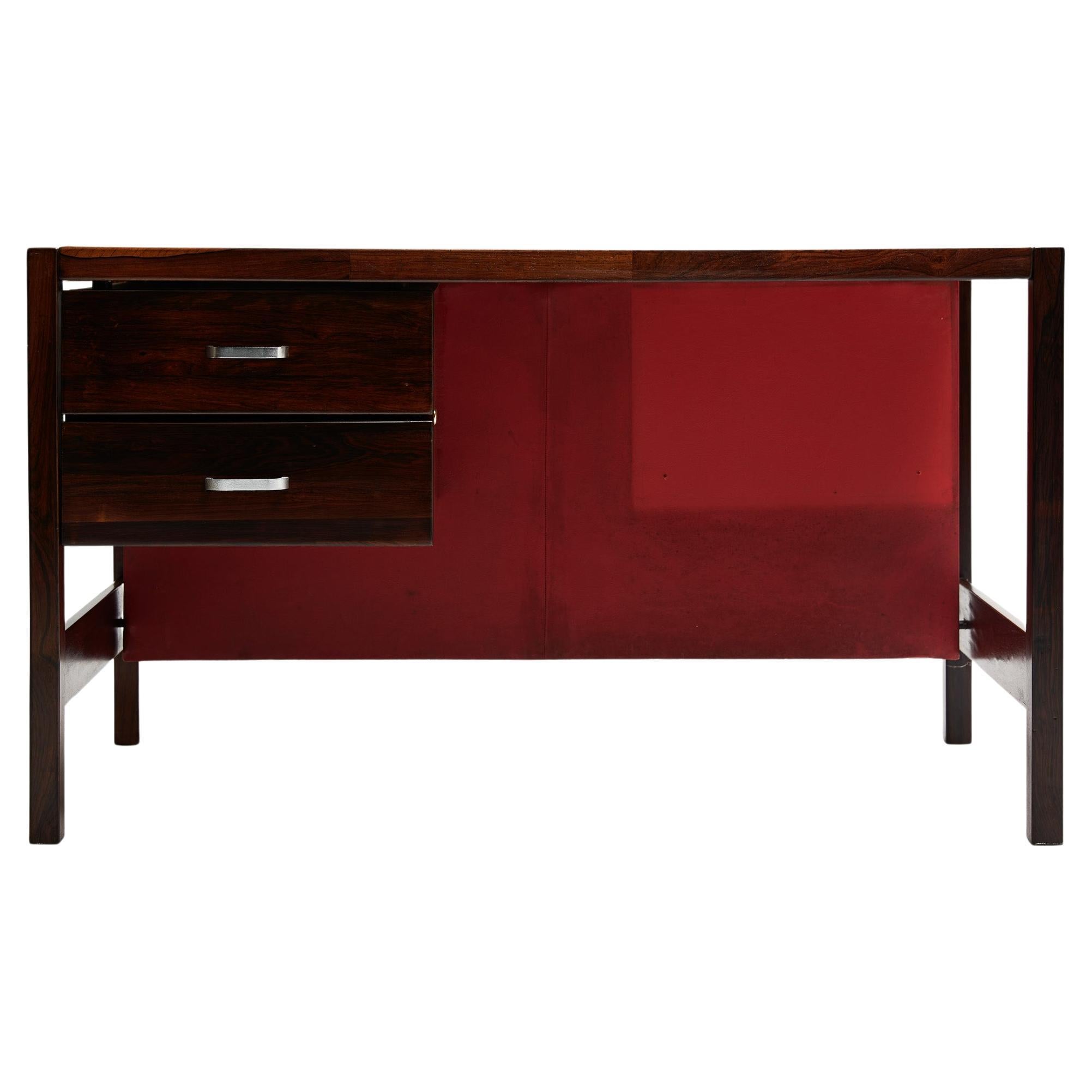 Available today, this Mid-Century Modern Desk in Hardwood by Jorge Zalszupin for L’Atelier in the sixties is stunning!

This beautiful desk is made in solid Brazilian Rosewood, known as Jacaranda and has two floating drawers with metal handles.