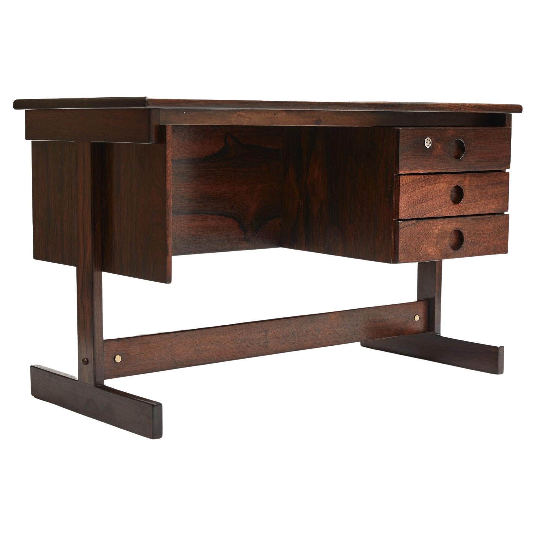 This Brazilian Modern Desk designed by Sergio Rodrigues is absolute stunning!

The structure has straight lines and is entirely made in solid Brazilian Rosewood (As known as Jacaranda) and white Formica on top. The Formica is new, and the wood has