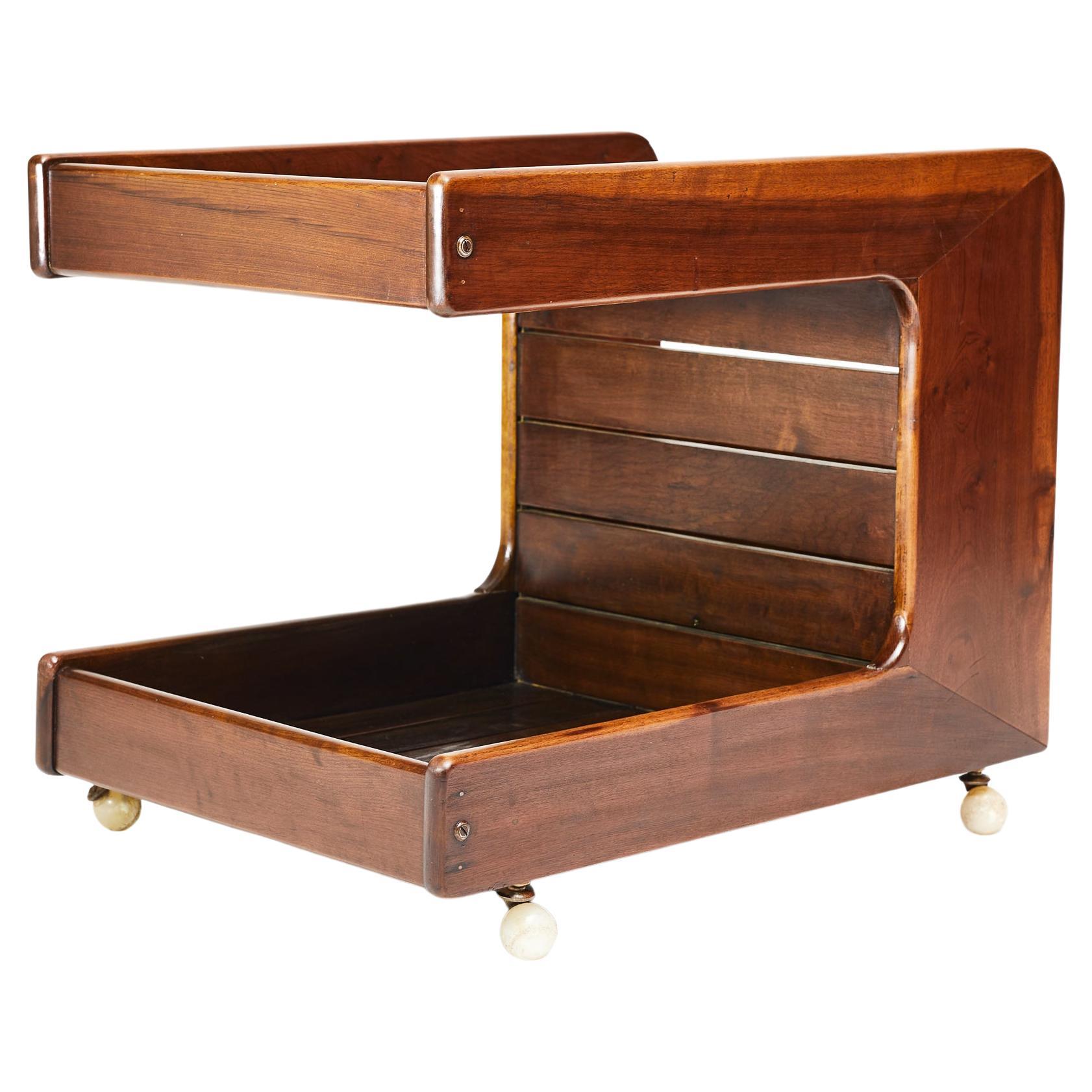 Available today, this one-of-a-kind Brazilian Modern bar cart in imbuia hardwood & alabaster wheels designed by Casa Finland in the sixties is stunning!

This rare, Mid-Century Modern gem is made in Imbuia hardwood and has four delicate, original