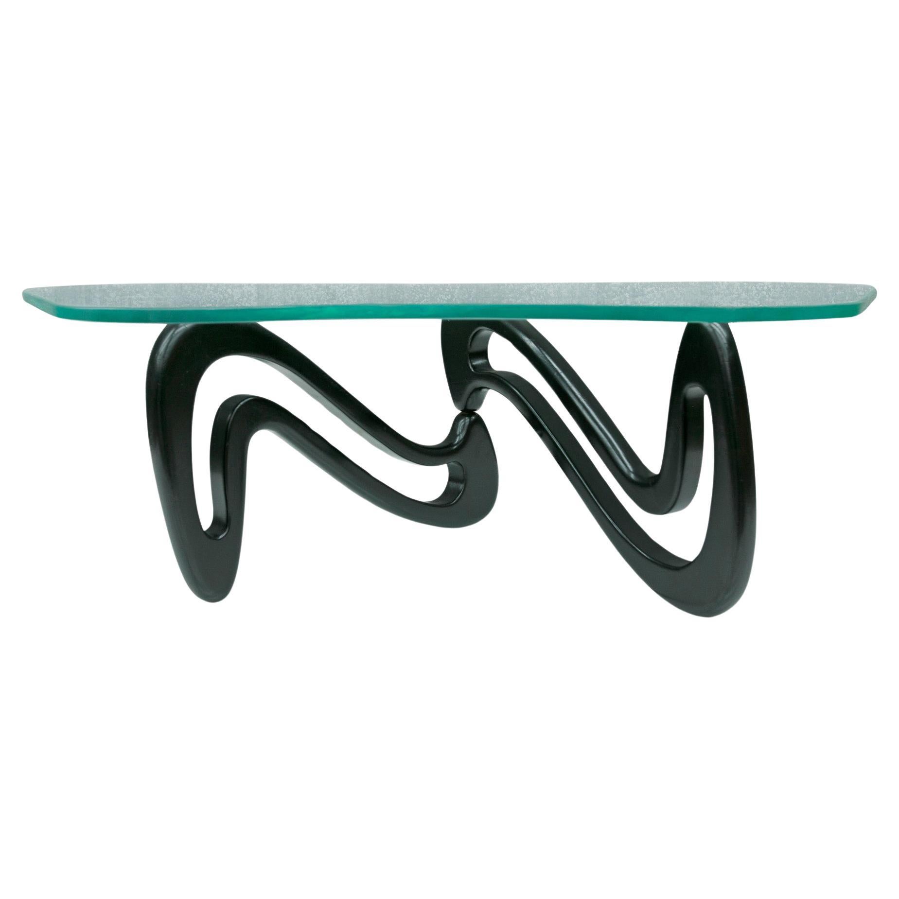 Available today, this one-of-a-kind Brazilian Modern coffee table model ACQUA made in Ebony wood and glass by Giuseppe Scapinelli, 1950s, Brazil is nothing less than spectacular.

There are three reasons why this iconic piece is so special: First,