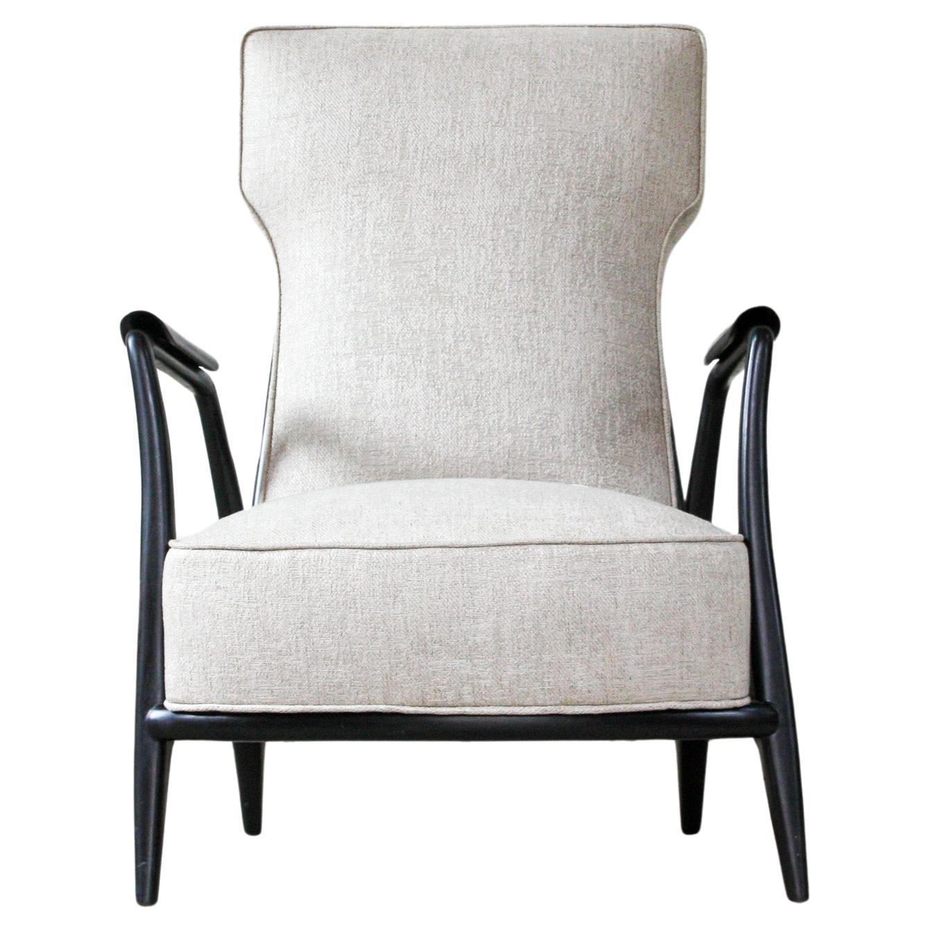 Available today, this sculptural Mid-Century Modern armchair in hardwood and grey fabric by Giuseppe Scapinelli made in the fifties is absolutely gorgeous!

The vintage armchair is made in Pau Marfim hardwood with Ebony finish in light gray