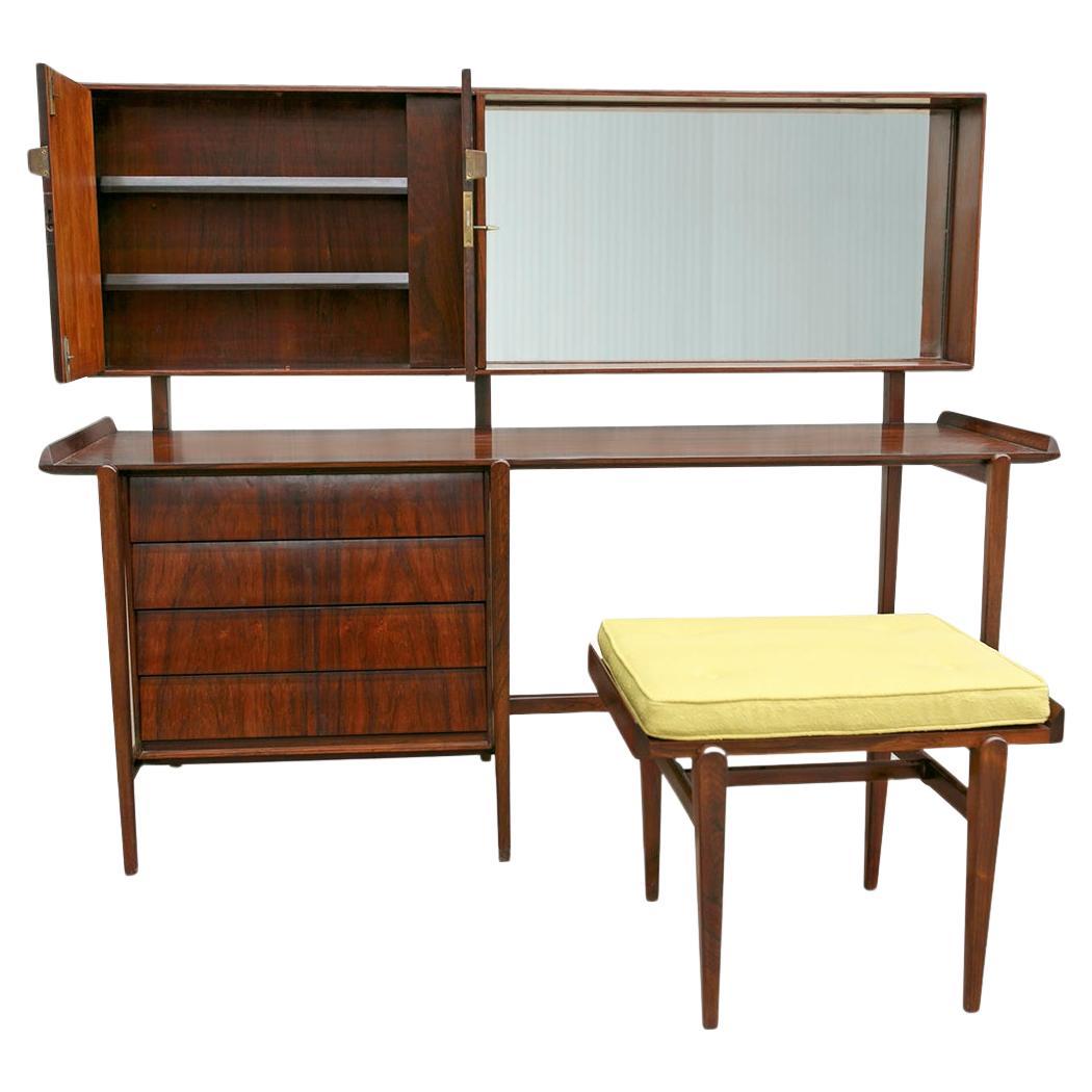 Available today, this Mid-Century Modern Dresser and Stool in Hardwood, by Carlo Hauner is nothing less than gorgeous!

This set comes with a stool and a dresser that has a mirror, four drawers, and one cabinet. The light in the dresser has been