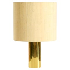 A very rare, large, and heavy 1970s brass table lamp with a wild silk shade
