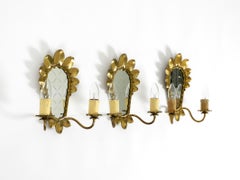 A set of three beautiful, rare mid-century modern brass wall lamps with mirrors