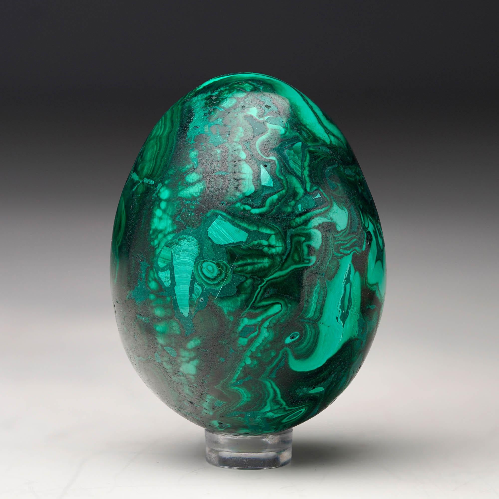 Crafted from solid, natural Malachite, this hand-polished crystal egg is a work of art: foregrounding the stone’s signature swirling green banding, contrasting bullseyes, and rich, natural luster. A mesmerizing décor piece.

Malachite has been mined