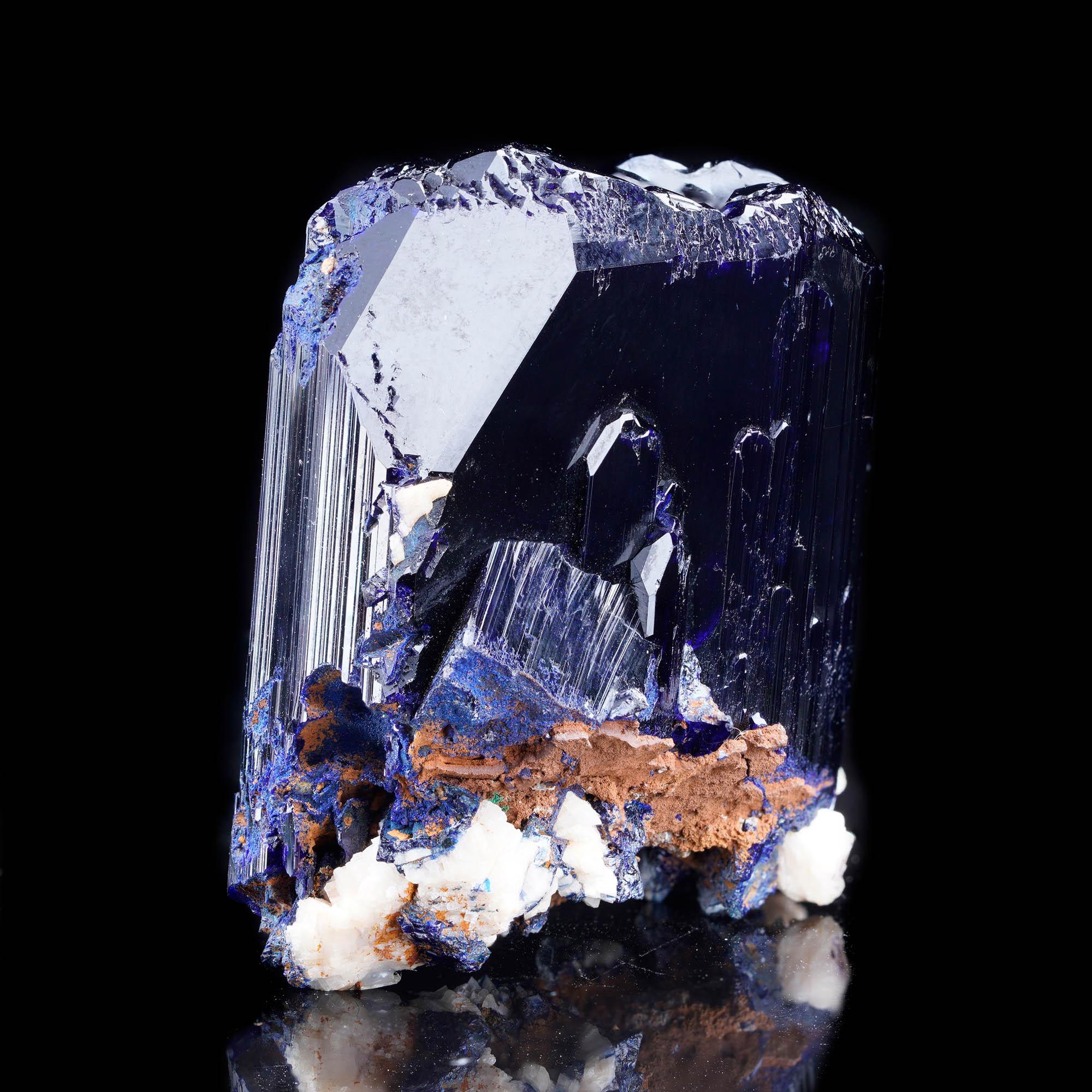 This spectacular large Azurite crystal from the legendary Tsumeb Mine in Namibia showcases perfect termination, intense color saturation, and exceptional mirror-like luster. The deep midnight blue of the azurite is accented at the base by natural