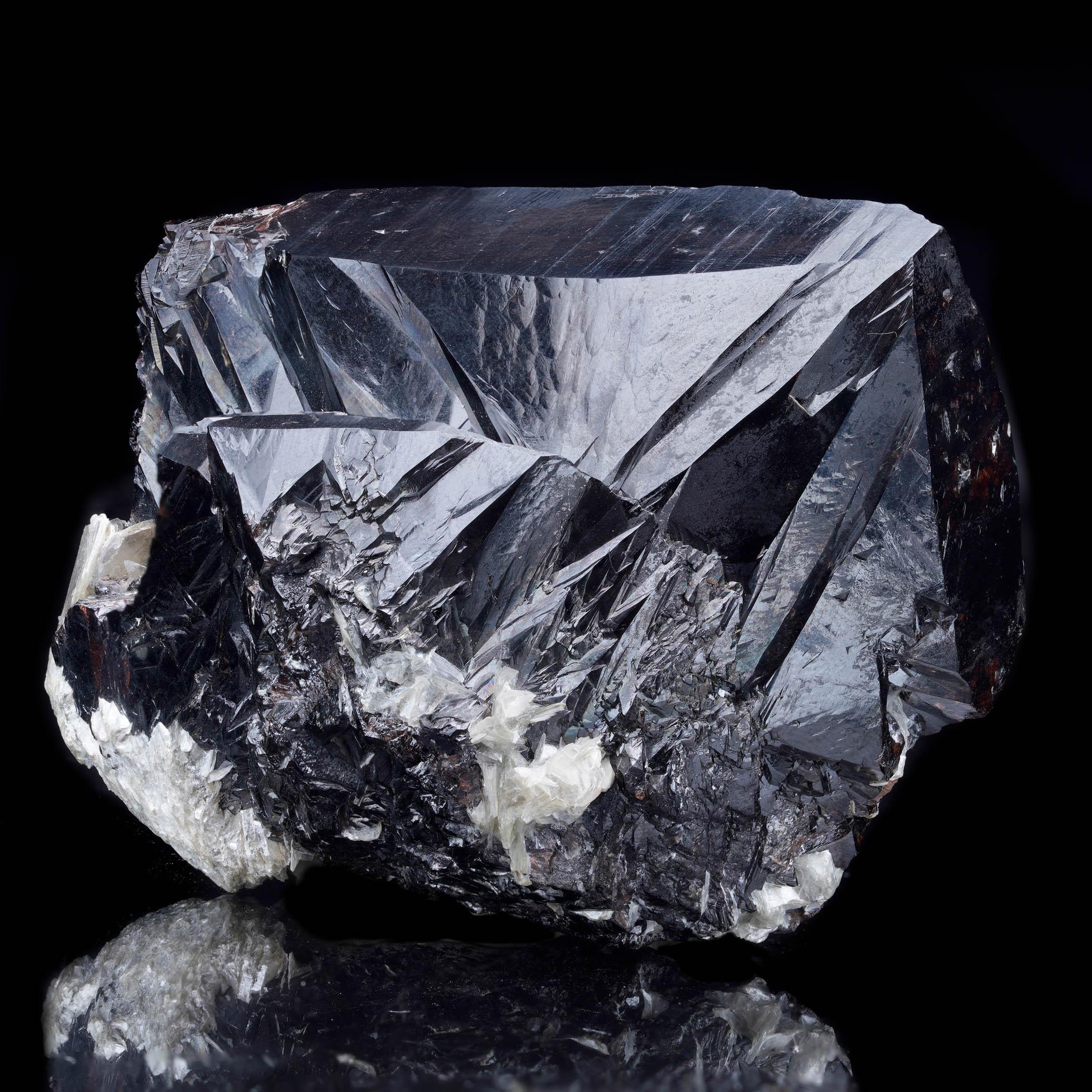 This sharply defined and exceptionally lustrous cluster of several large Cassiterite crystal comes from the renowned Pingwu Mine in Sichuan Province, China. Featuring bold, reflective black crystals with dramatic geometric faces, this piece displays