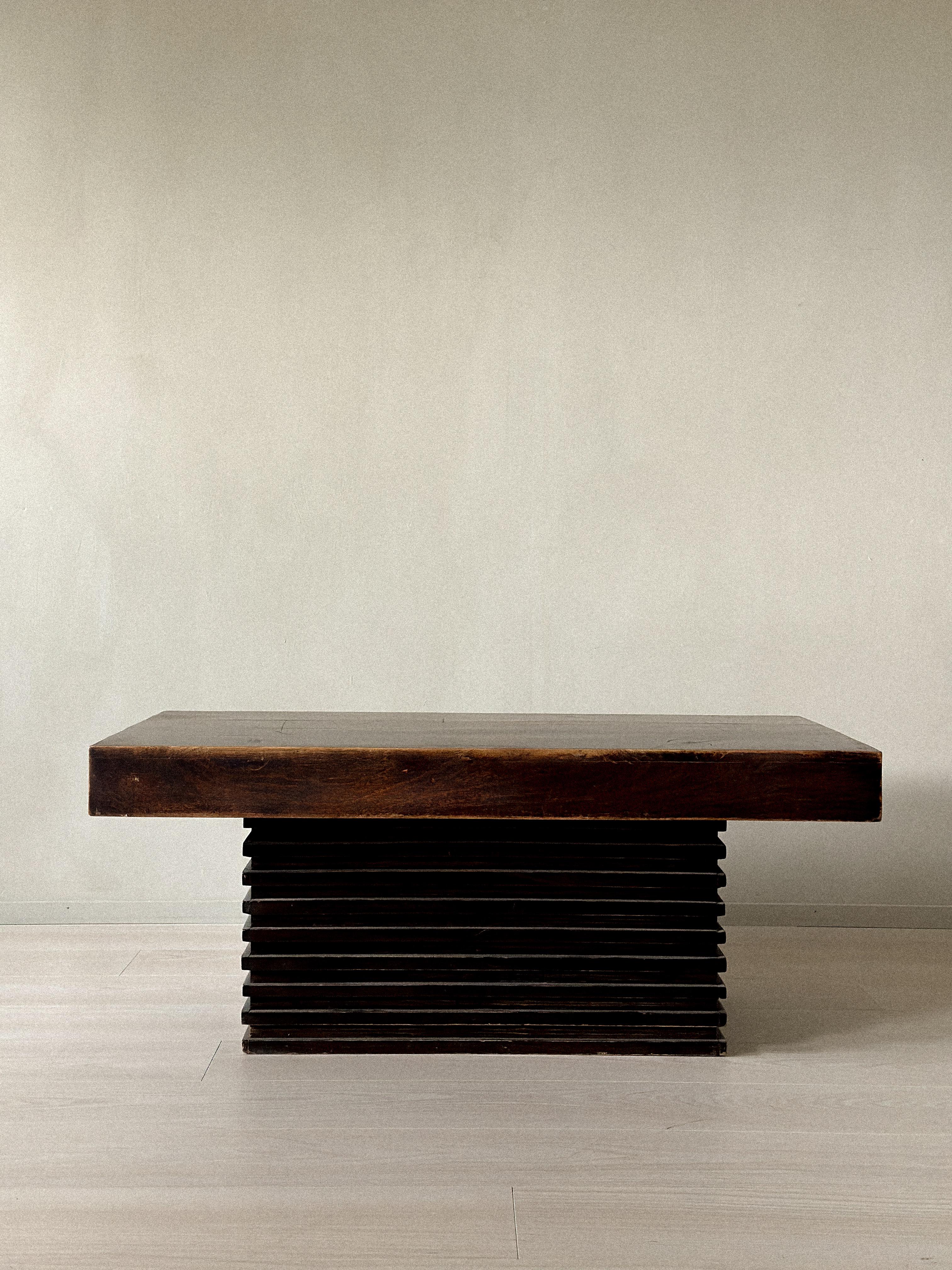 Rectangular coffee table with thick solid top and stacked slatted base. Dark-stained wood with rich patina. Likely produced in Spain, circa 1960s. Wear consistent with age and use. 