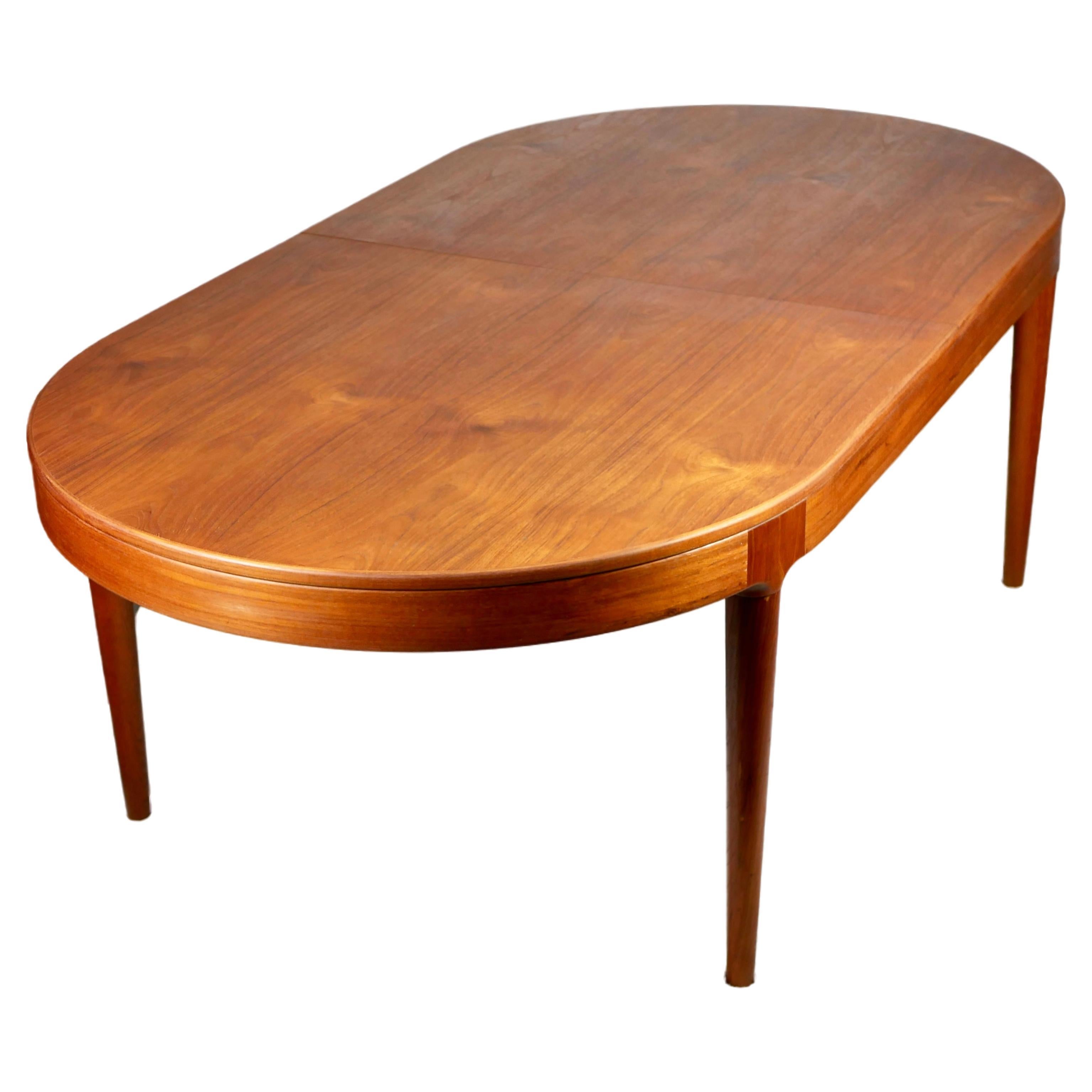 Large danish expandable teak table by Arne Hovmand-Olsen for Mogens Kold, 1960s