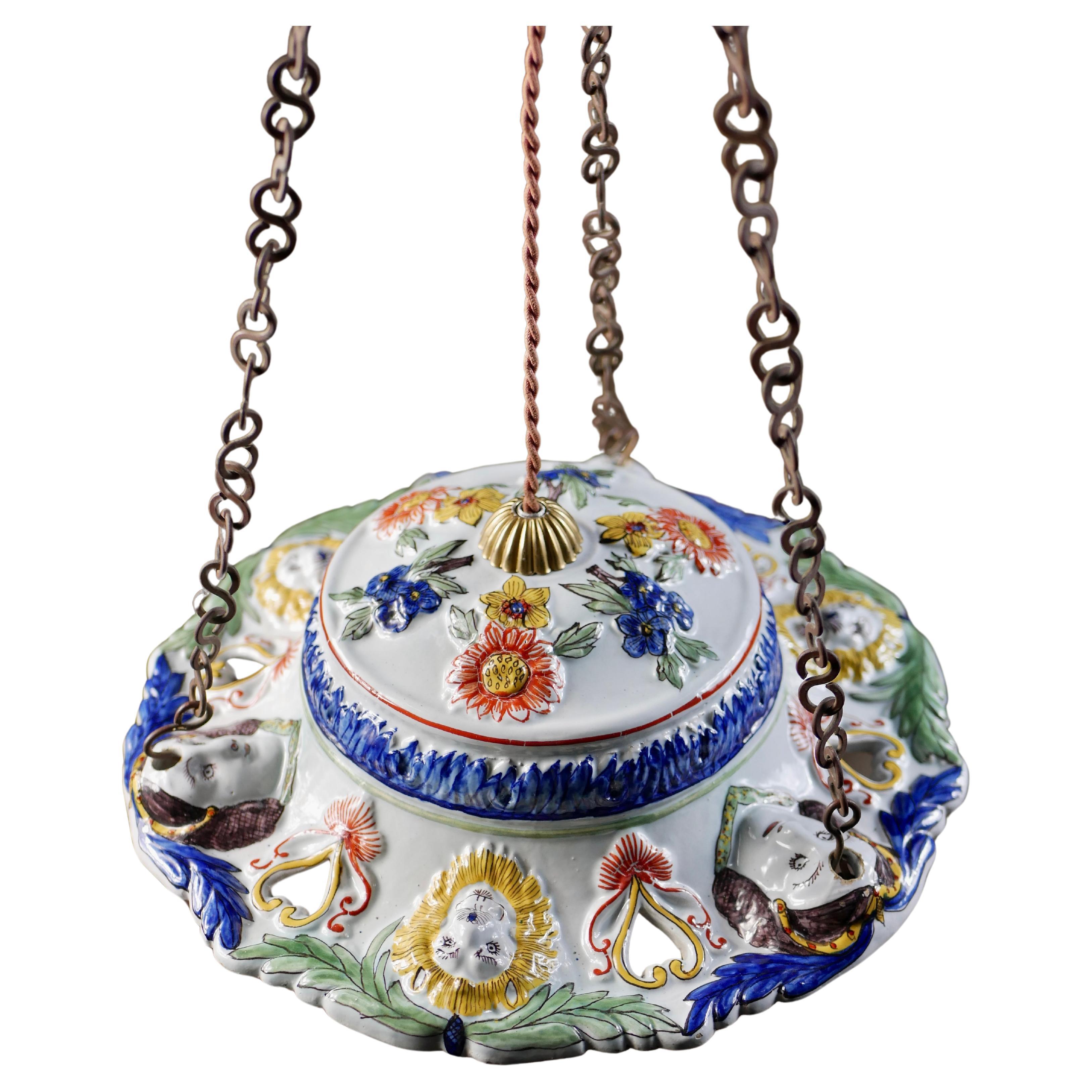 Beautiful and rare former pendant bowl from the late 19th century, made in Sicily, that has been transformed into a chandelier.
Polychrome earthenware with flowers, woman and lion faces decorations that have been hand-painted and are absolutely