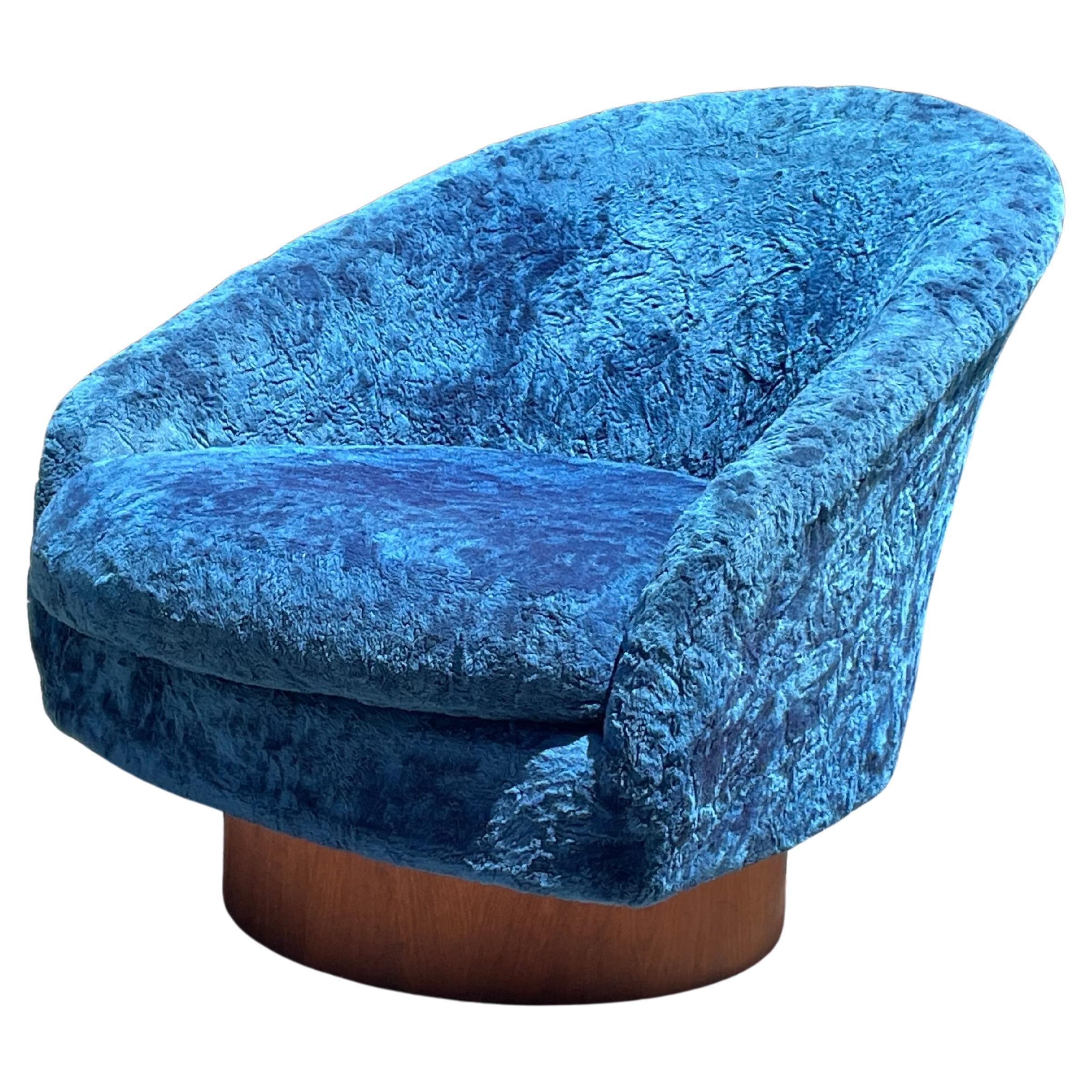 All original magnificent mid-century Adrian Pearsall swivel lounge chair with in blue velvet. The chairs features a swivel rocker walnut base. Super comfortable. Swivel and rock. USA, 1970s.

Great lines on this chair.

Very good original vintage