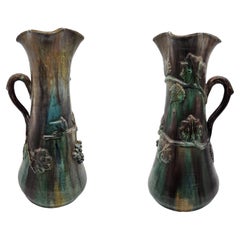 Title: Pair of Antique Glazed Ceramic Ewers with Naturalistic Relief Decoration