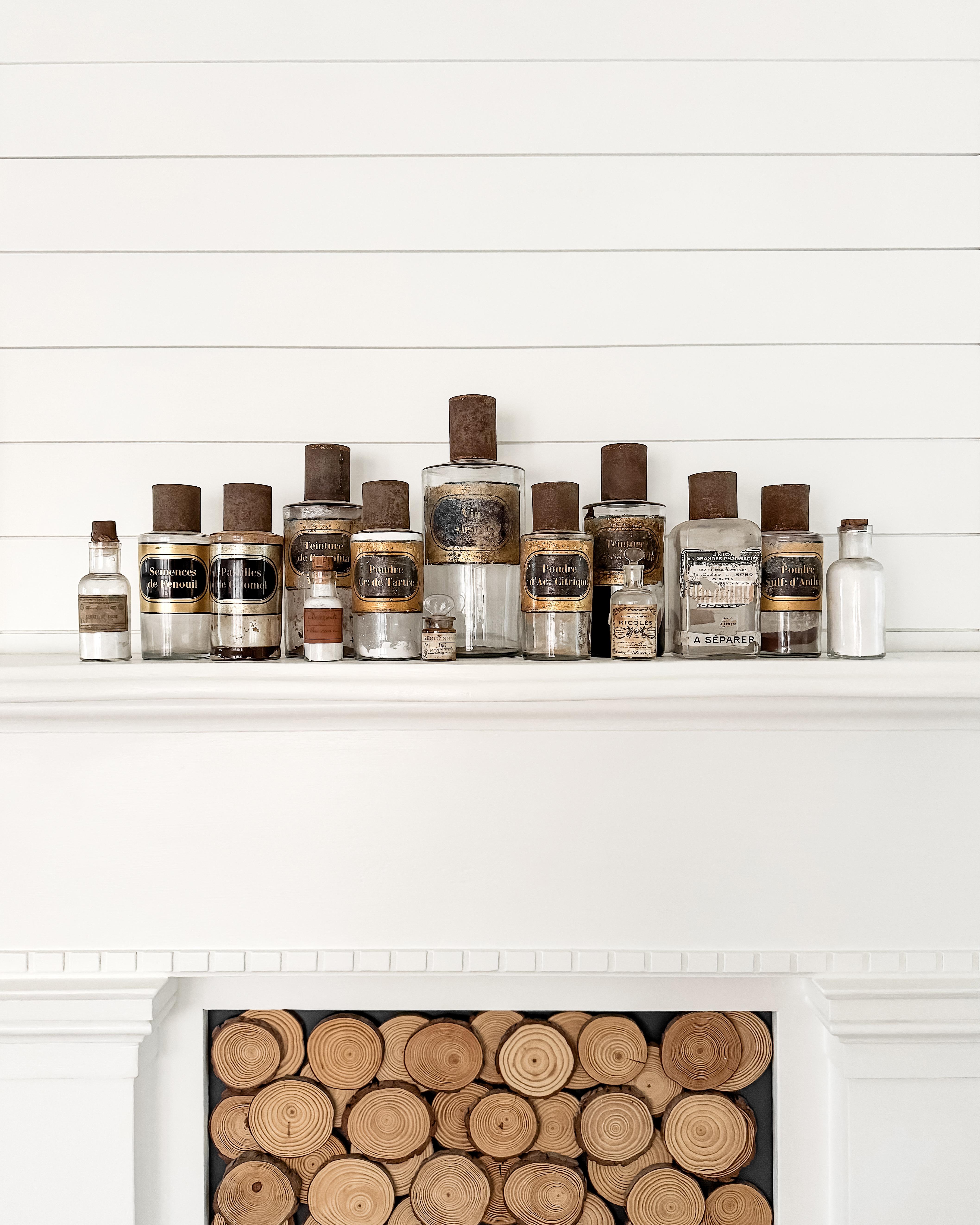 A striking collection of 14 antique French apothecary bottles, dating from the late 19th to early 20th century. Each glass vessel once held medicinal powders, tinctures, or remedies, and still wears its original paper label — some preserved in crisp