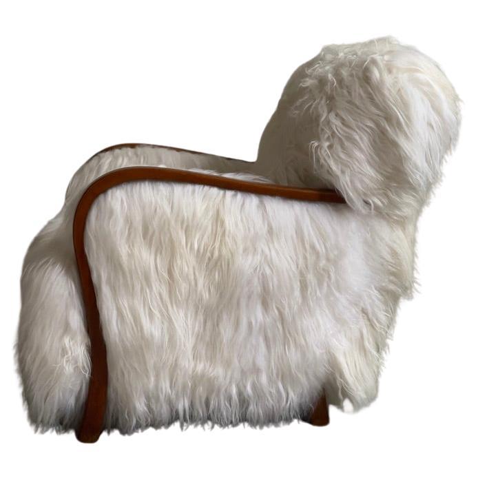 1940s Danish Lounge chair reupholstered in long haired Icelandic sheepskin. For Sale