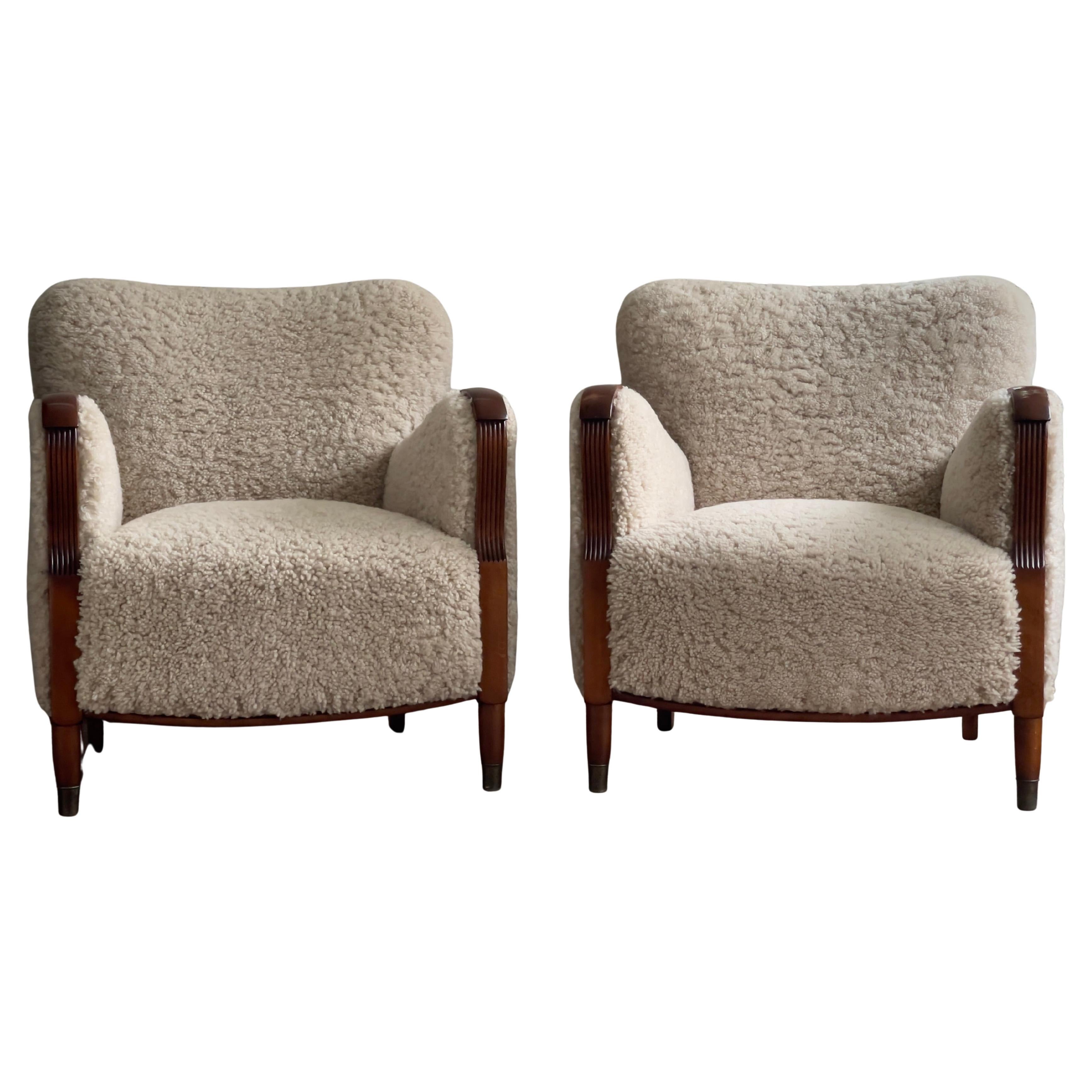 Pair of 1930s Art Deco danish lounge chairs reupholstered in natural sheepskin.
