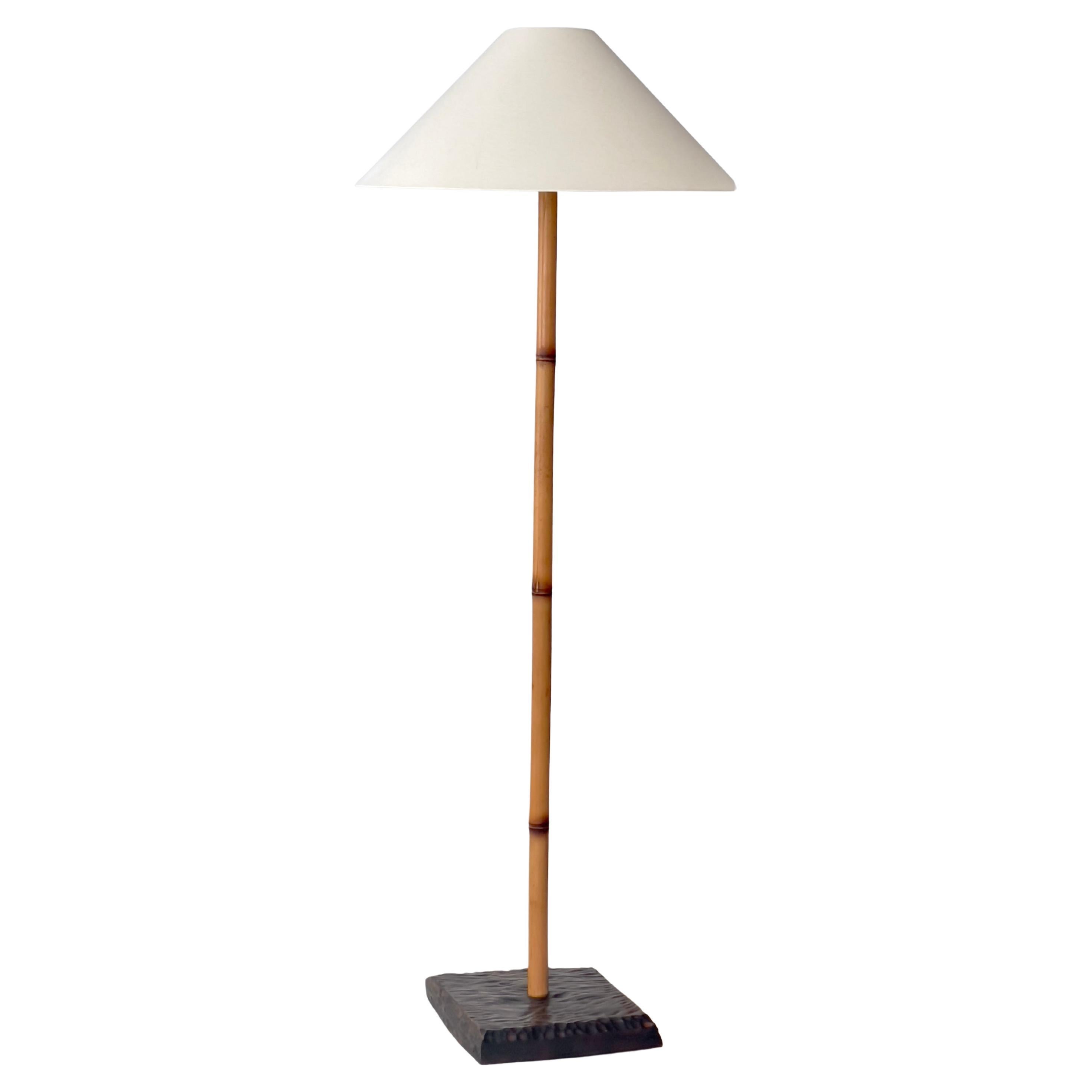 Rare Finnish 1960s floor lamp in patinated bamboo rattan and stained oak base.