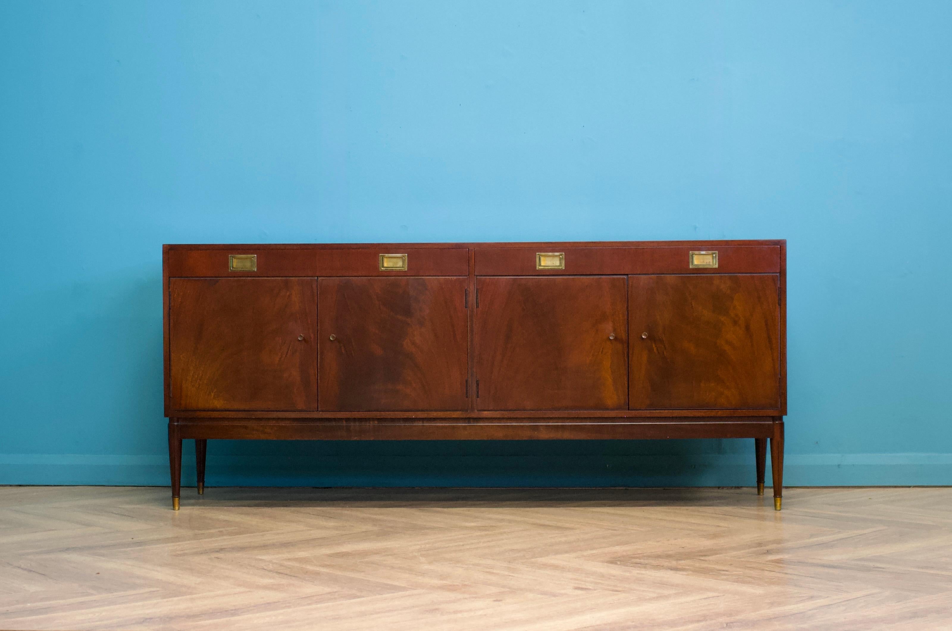 A mid century mahogany sideboard from Greaves and Thomas, circa 1960s 




There are two cupboards, each with a shelf and two drawers.