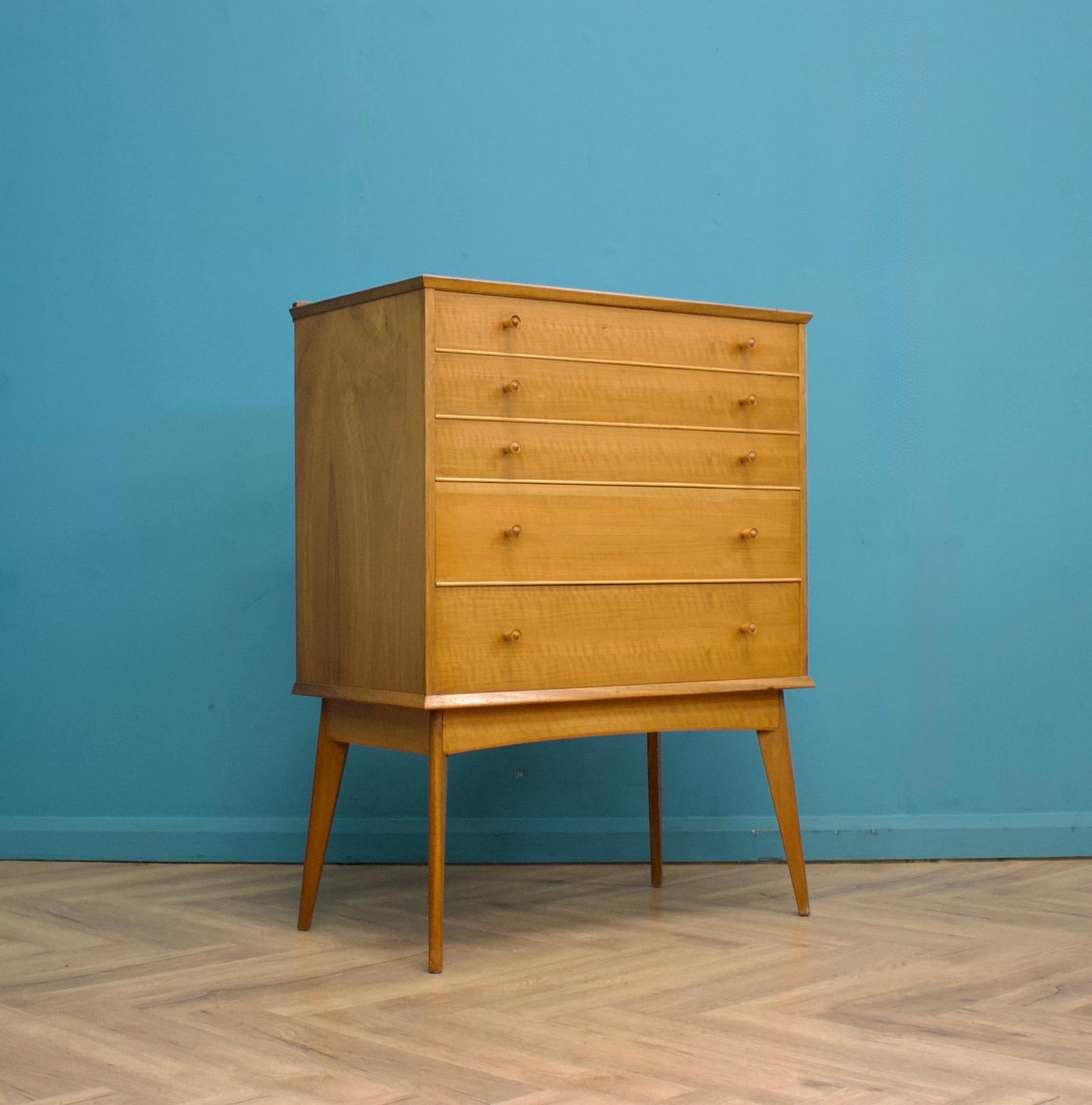 An impressive quality, tall walnut chest of drawers from Alfred Cox - retailed through Heal's during the 1950s
The bank of five drawers stands on long, tapered, splayed legs
The manner of construction of the legs means they are very sturdy and