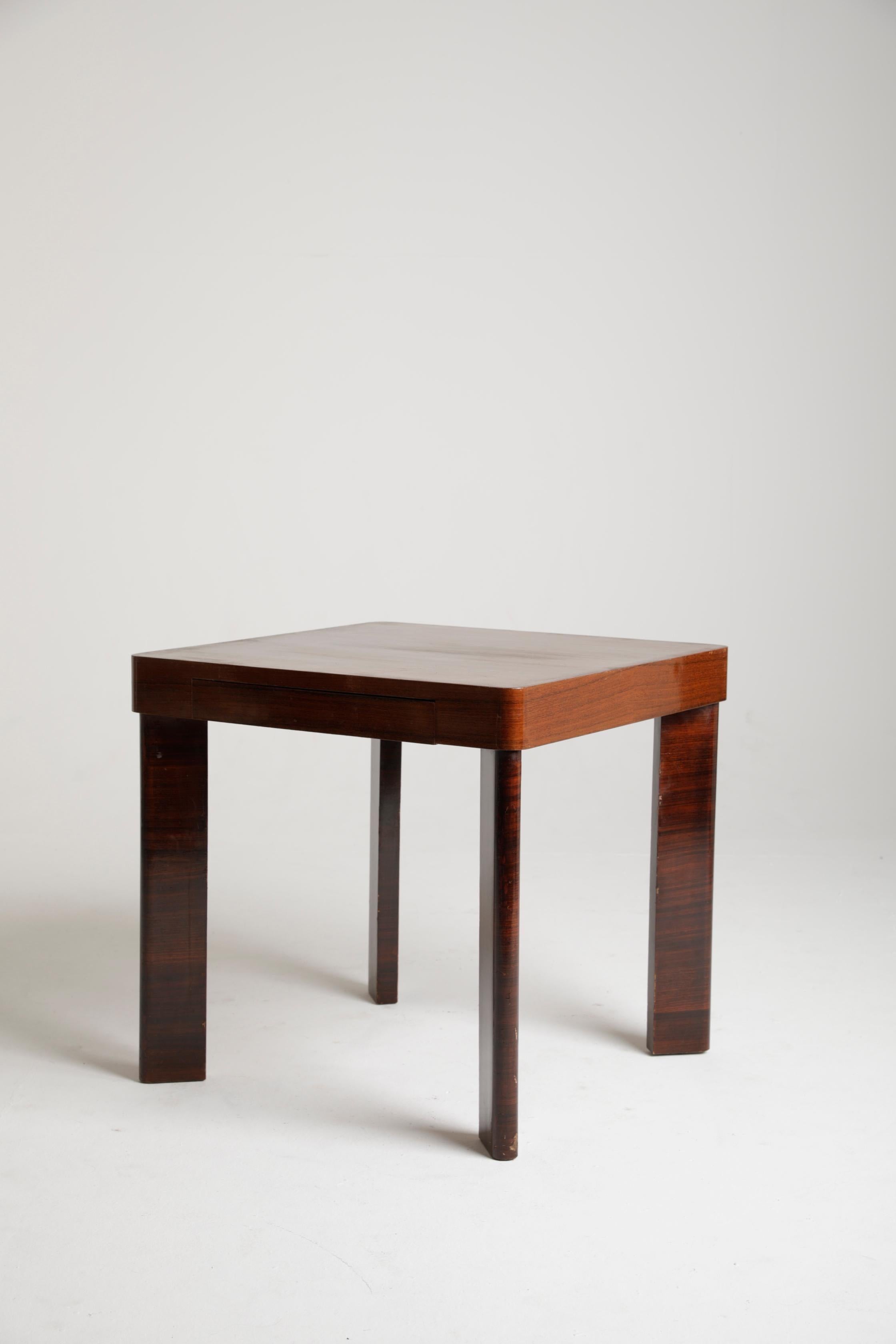 Game table made by the Bolognese architect Melchiorre Bega for an important Bolognese residence in the mid-1930s. The work represents a brilliant synthesis between the art déco style, from which it takes up the use of different precious woods, and