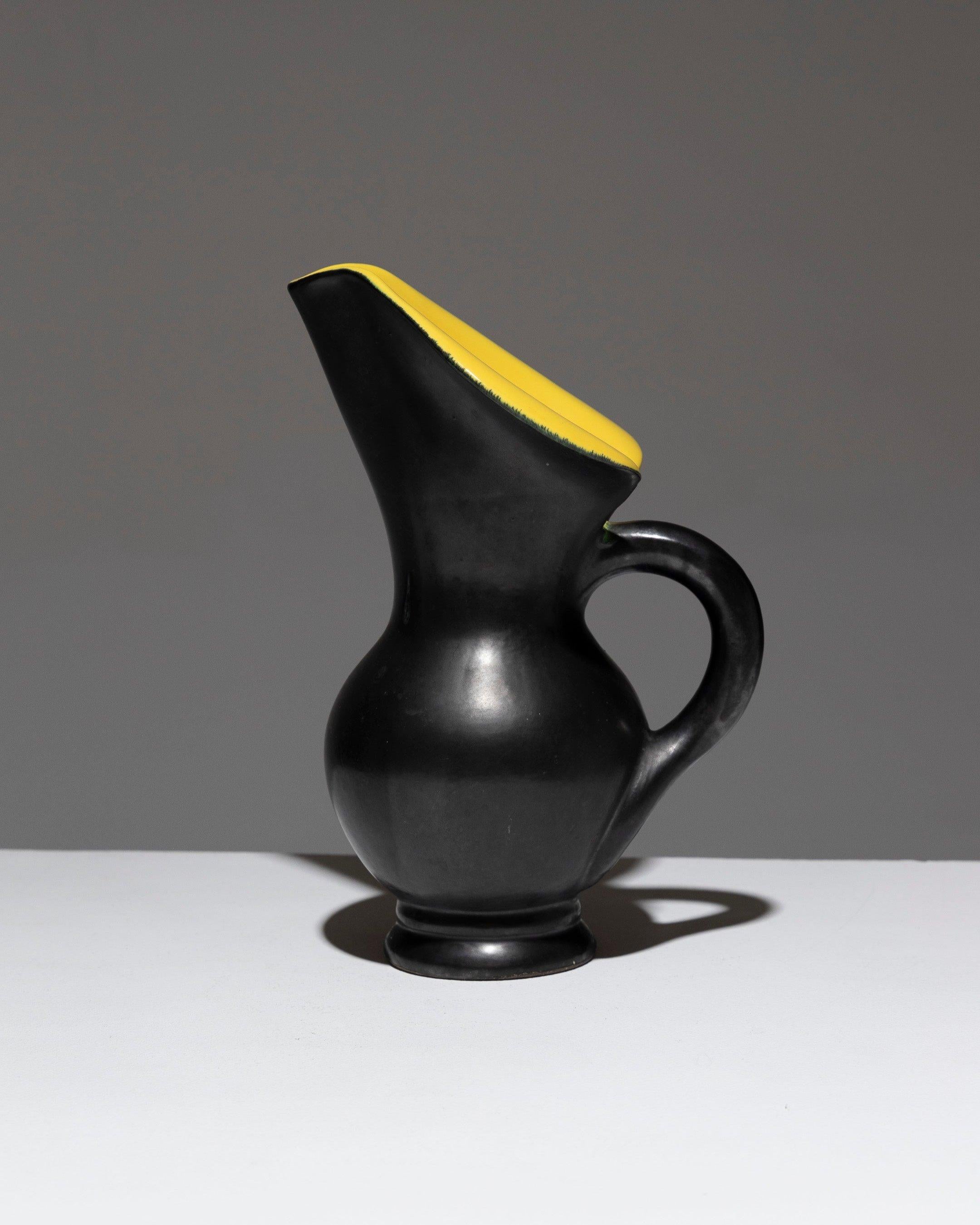Free-Form Pitcher in Ceramic, Vallauris, 1950s, in the style of Pol Chambost. Featuring wide, flared, and rolled edges. The exterior is a matte black 