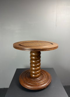 Tavolino basso e massiccio in legno tornito, in stile Charles Dudouyt, anni '50