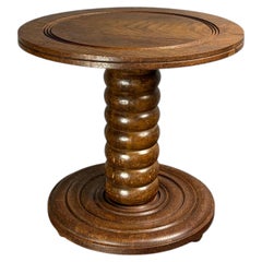 Tavolino basso e massiccio in legno tornito, in stile Charles Dudouyt, anni '50