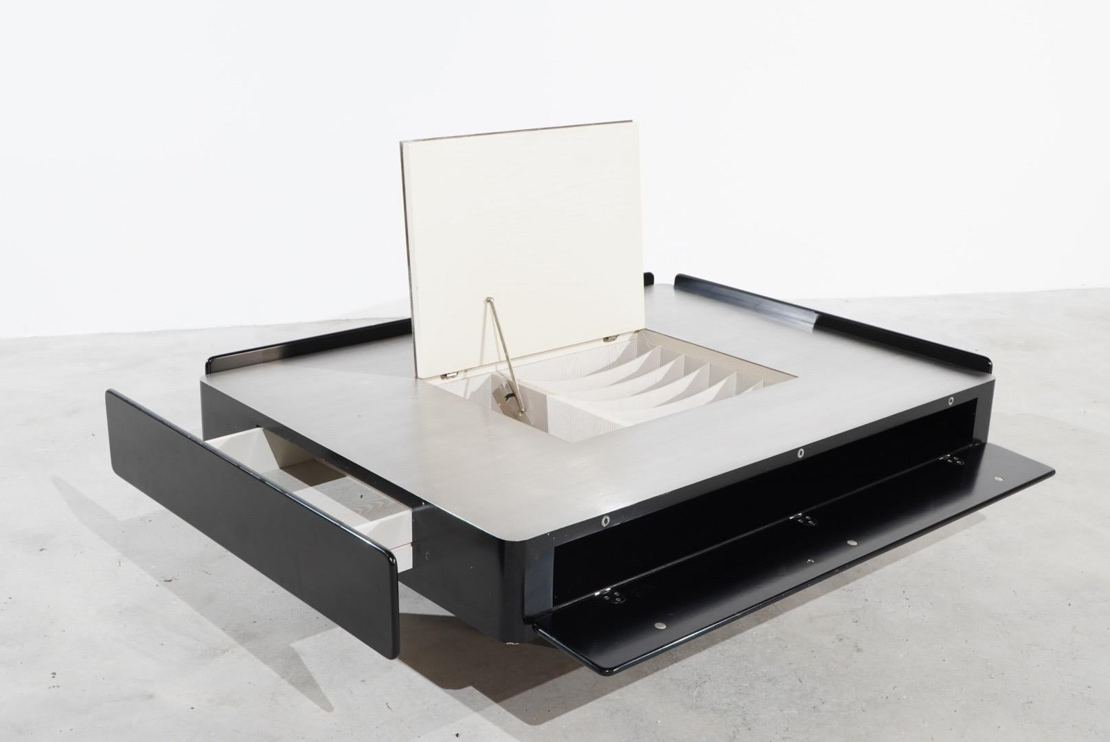 Beautiful Coffee Table by the famous italian Designer Vico Magistretti called ,,Caori“ , manufactured by Gavina in the 1960s. The coffee table is made of lacquered wood. The top is in satin-finished stainless steel and has a central opening with a