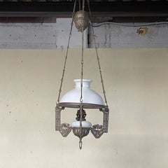 Antique Art Nouveau-style oil lamp with a pull-chain mechanism