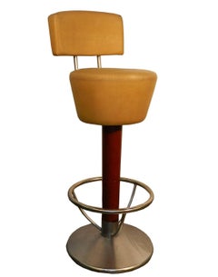 Suite of four bar stools, stained beech, steel and faux leather, circa 1970.