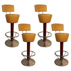 Suite of four bar stools, stained beech, steel and faux leather, circa 1970.