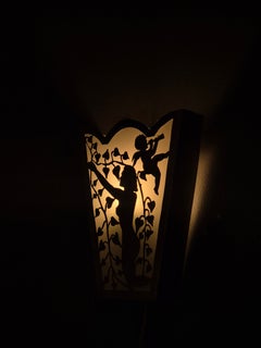 Swedish Grace wall light, decor of woman & cherub. white metal & glass, 1930s.