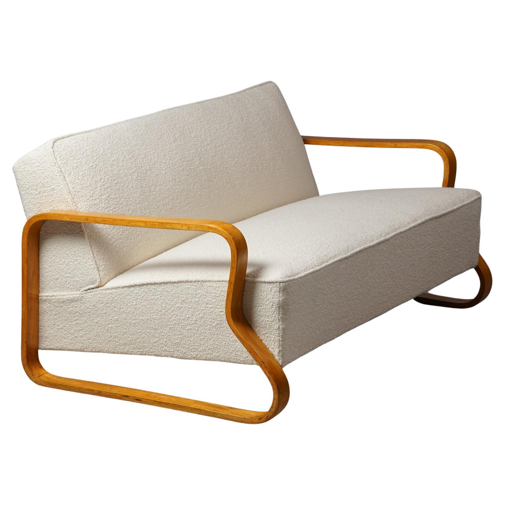 Exceptionally Rare Sofa Model '544', designed by Alvar Aalto for Artek,
Finland. 1932.

Bent birch and upholstered with Lauritzon's quality fabric. 

Early example. Marked.

Alvar Aalto tested the limits of plywood manufacturing in the early