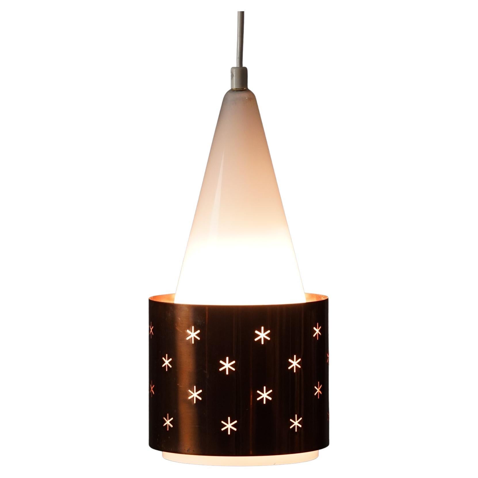 A rare pendant model K-14 by Paavo Tynell and produced by Idman in 1950s. Copper and opal glass. 

The way the light filters through the copper shade and from the glass gives you the starry effect.