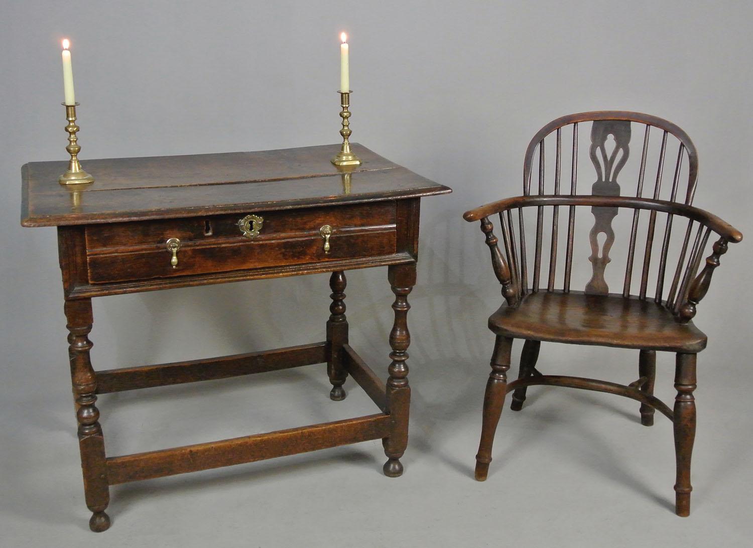 A very good and early English oak lowboy, all original, and with a fantastic colour and patina.

Peg jointed and solid throughout, the twin boarded oversailing top having a rich deep patina (the boards with a natural slender shrinkage gap between