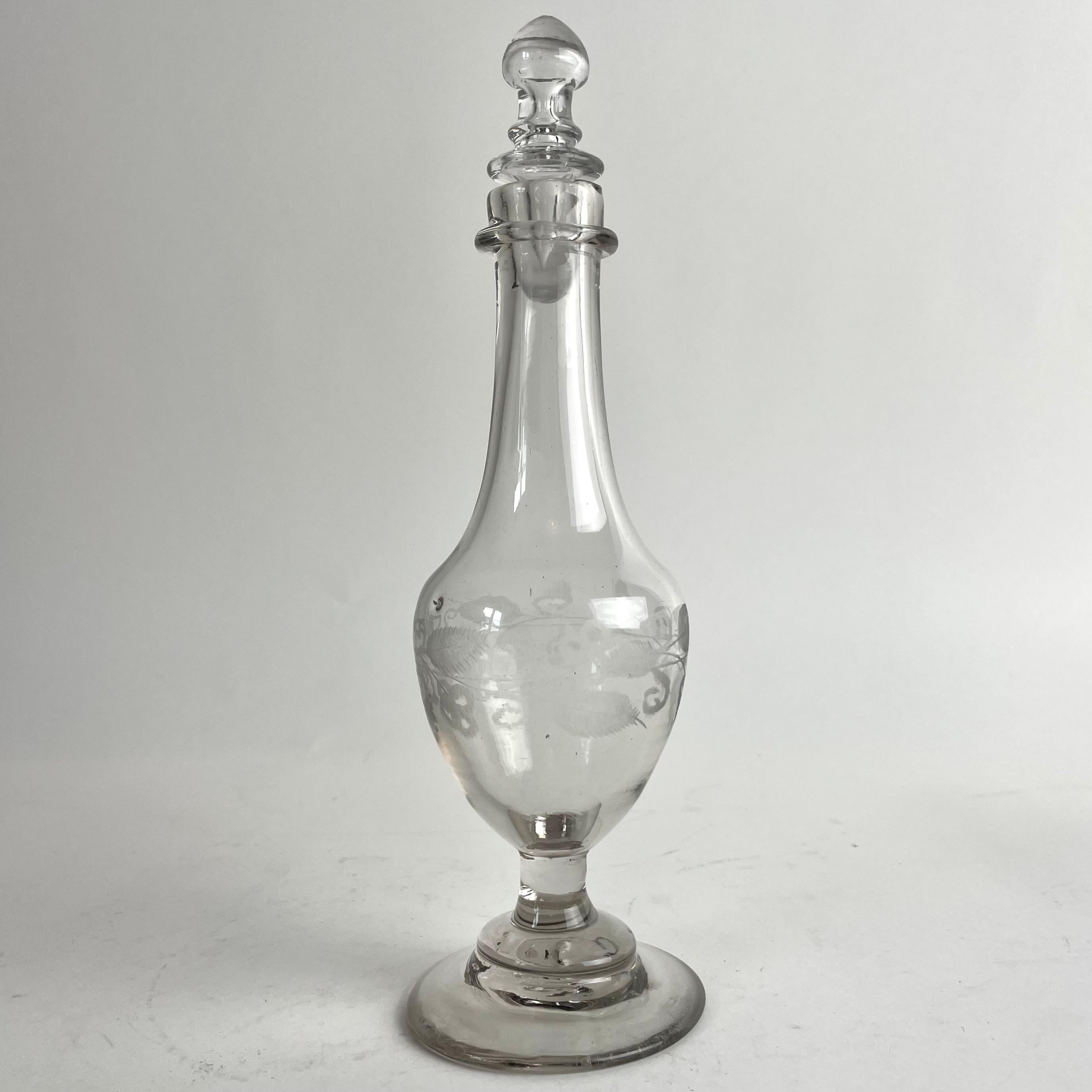 Charming Gustavian Handblown Glass Bottle with Stopper, Late 18th Century

This delightful Swedish Gustavian glass bottle from the late 1700s features handblown craftsmanship with engraved decoration. The glass bears subtle air bubbles, a slightly