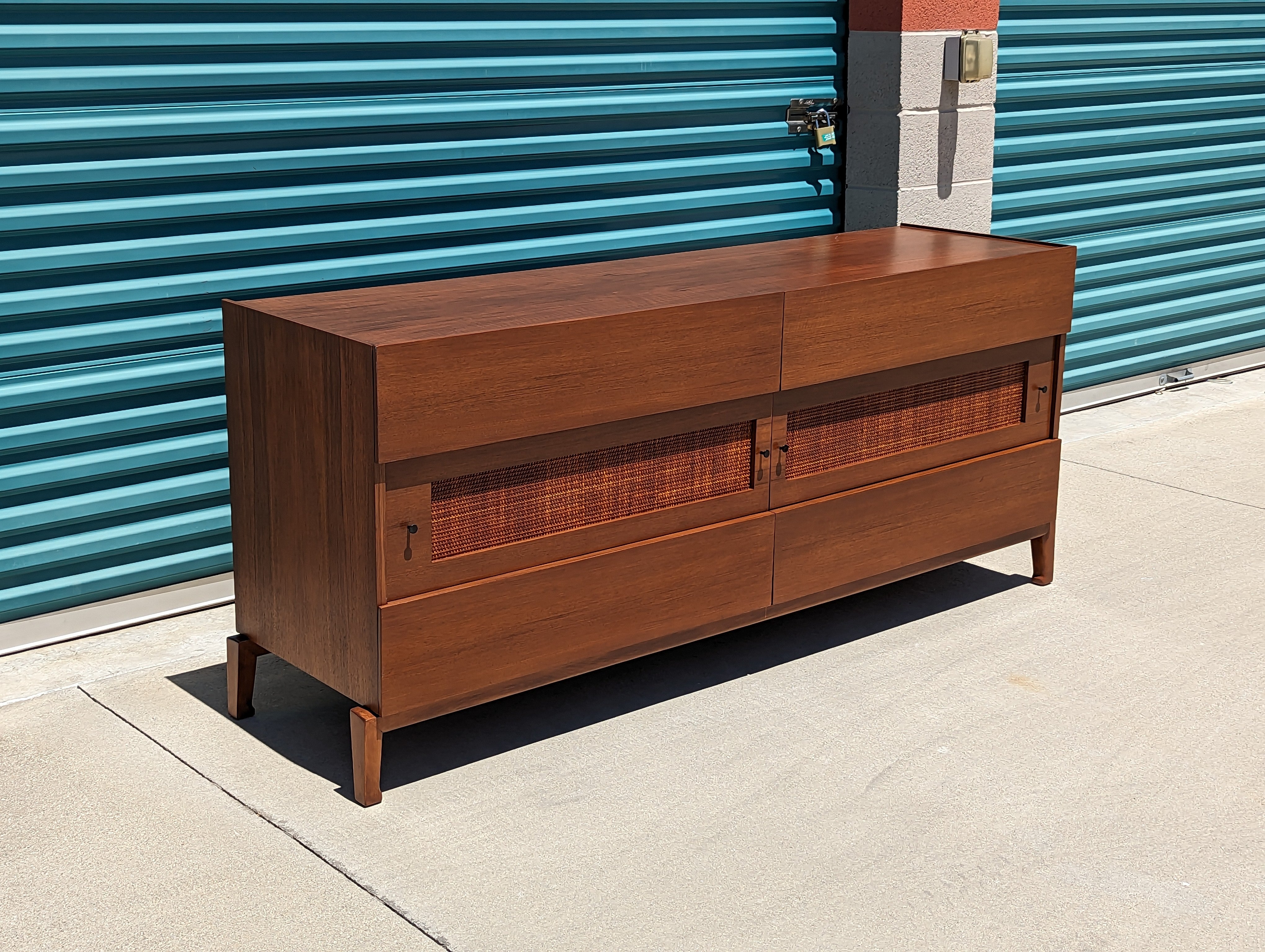 Elevate your living space with a touch of timeless elegance courtesy of this exquisite Swedish Mid Century Modern Walnut Dresser by renowned designer Edmond J. Spence, dating back to the captivating 1950s. A coveted gem, recently discovered in the