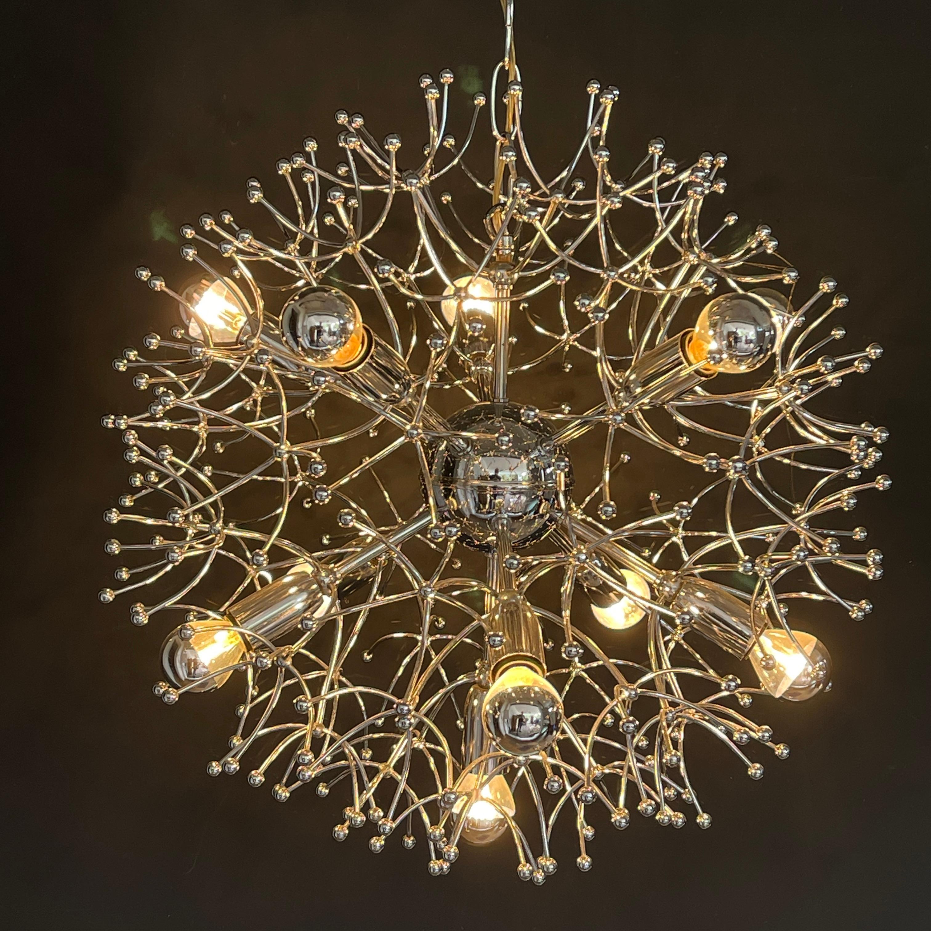 Sputnik ceiling lamp by Sciolary - 1970s.

The striking design of this ceiling lamp consists of delicate chrome leaves that radiate from the central core. The arrangement is reminiscent of the feathery seeds of a dandelion blowing in the wind. The