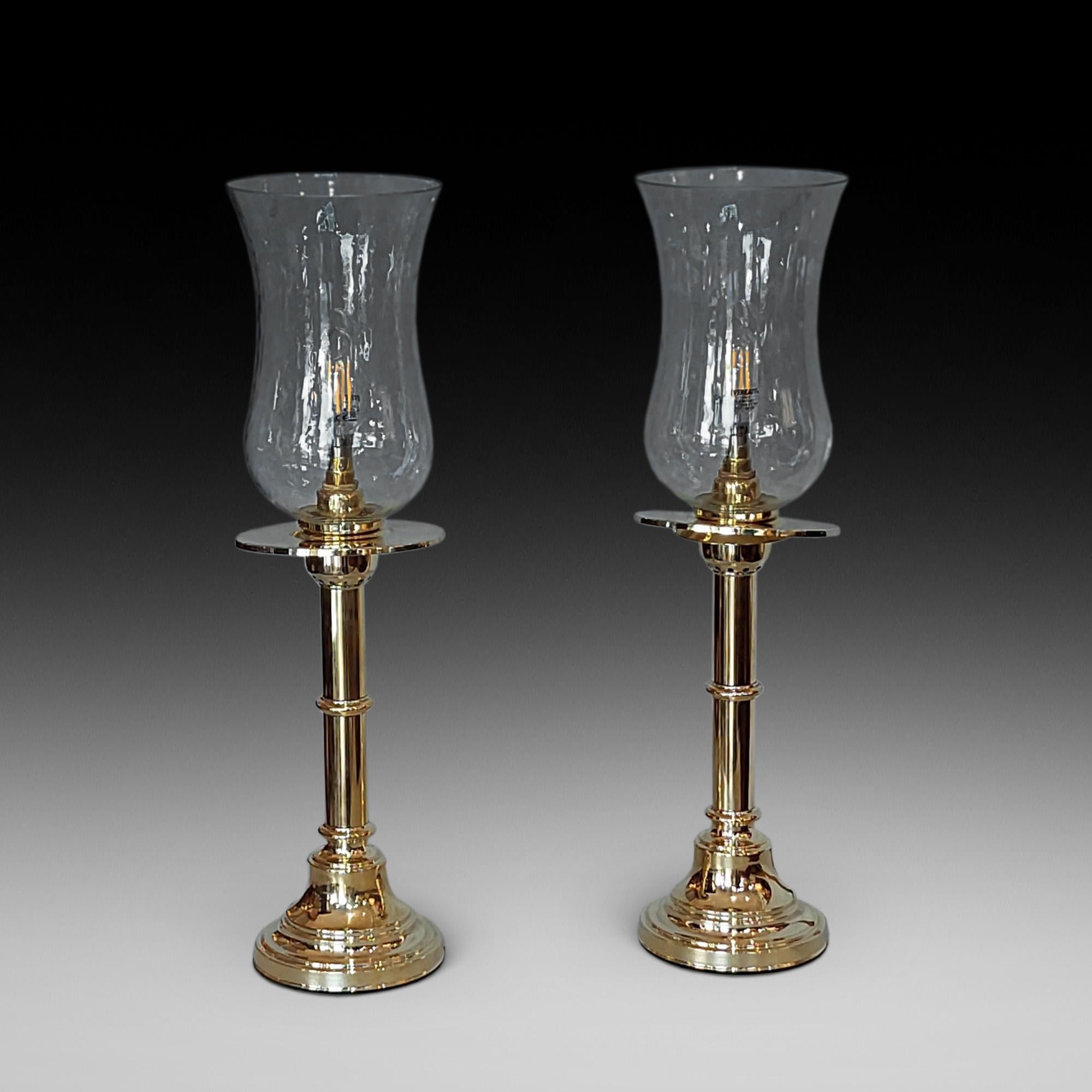 Pair of 19th century turned brass table lamps with weighted bases and spring loaded candle lights, with waisted spiral glass shades - all lights and lamps have been rewired with authentic corded flex, fitted with either foot switch or finger clicker