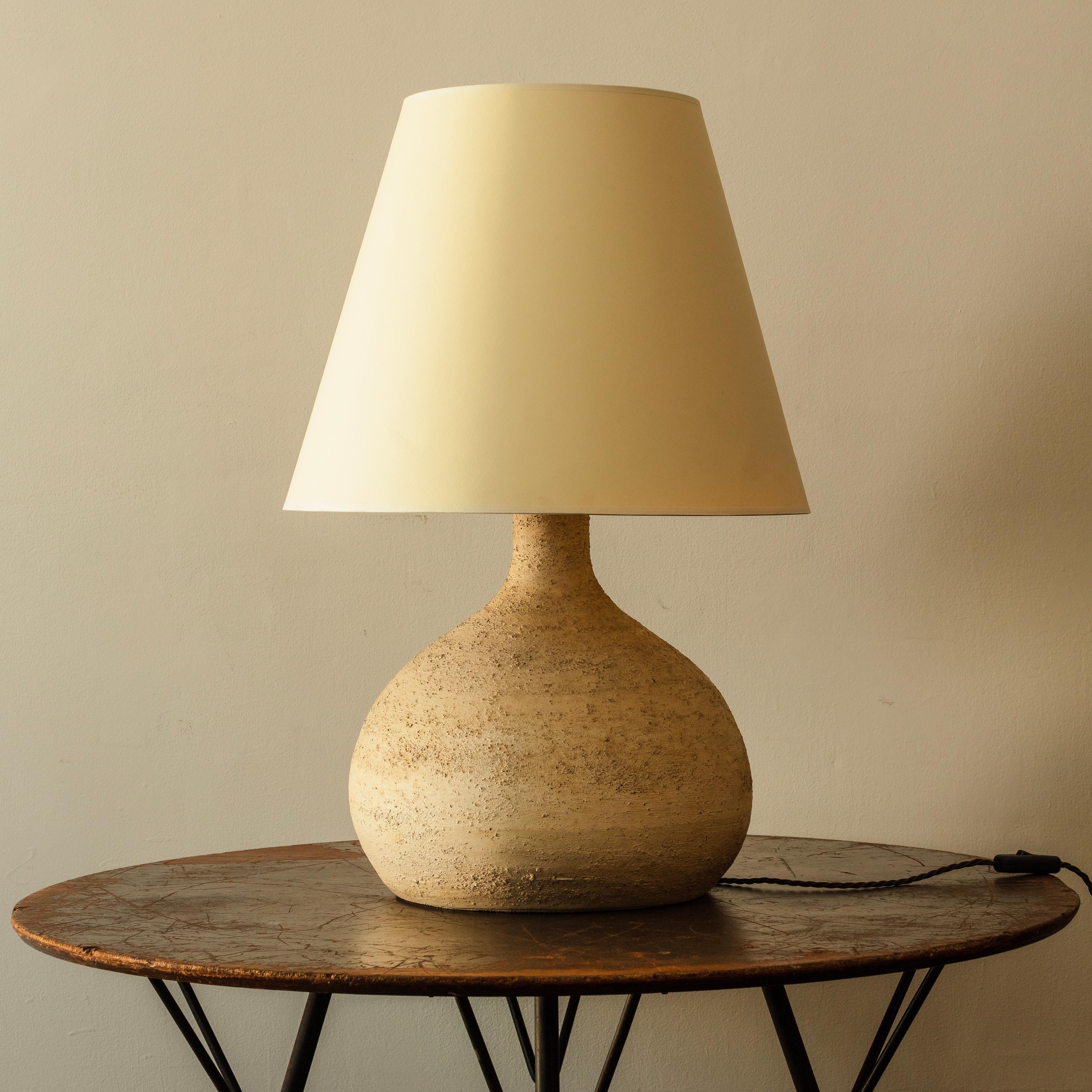 Heavily textured ceramic table lamp base with neutral card shade. Good large size.
South of France, 1960s

Dimensions: H71cm to top of shade x 32cm base diameter.
  