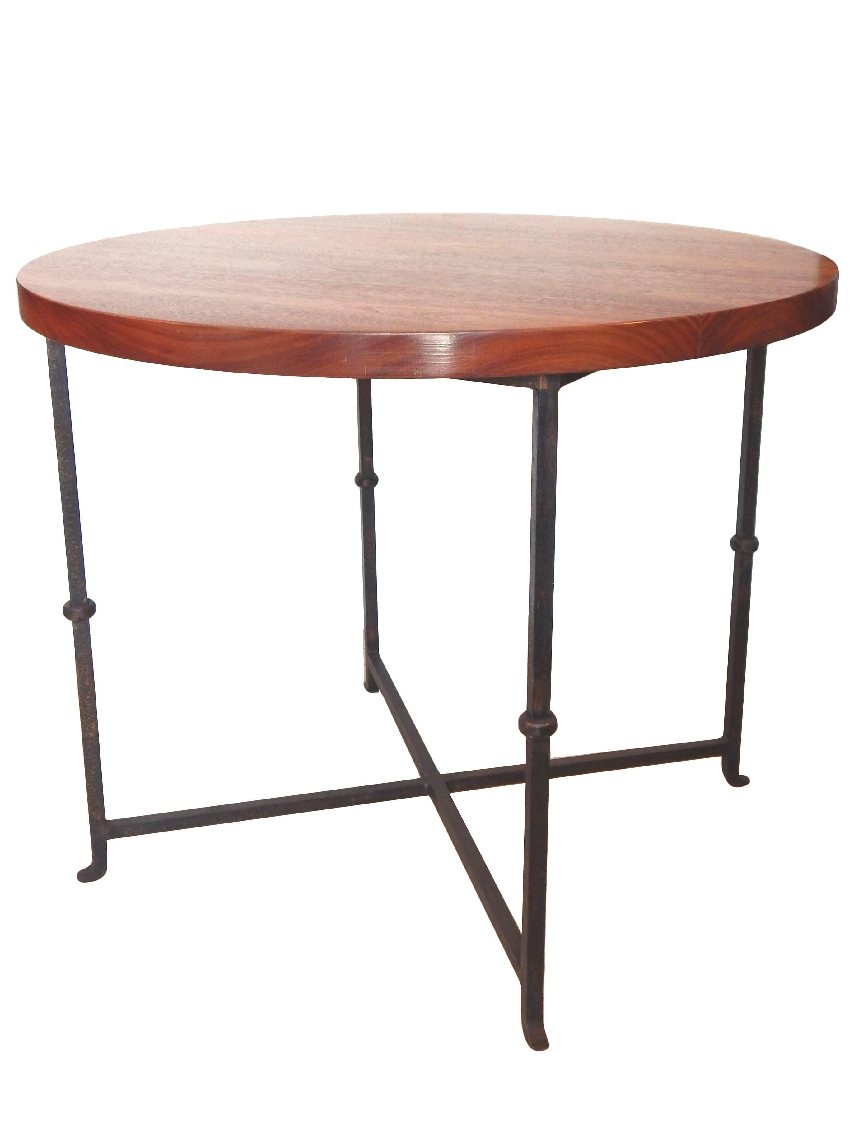 Round table with iron base with refinished wood top.