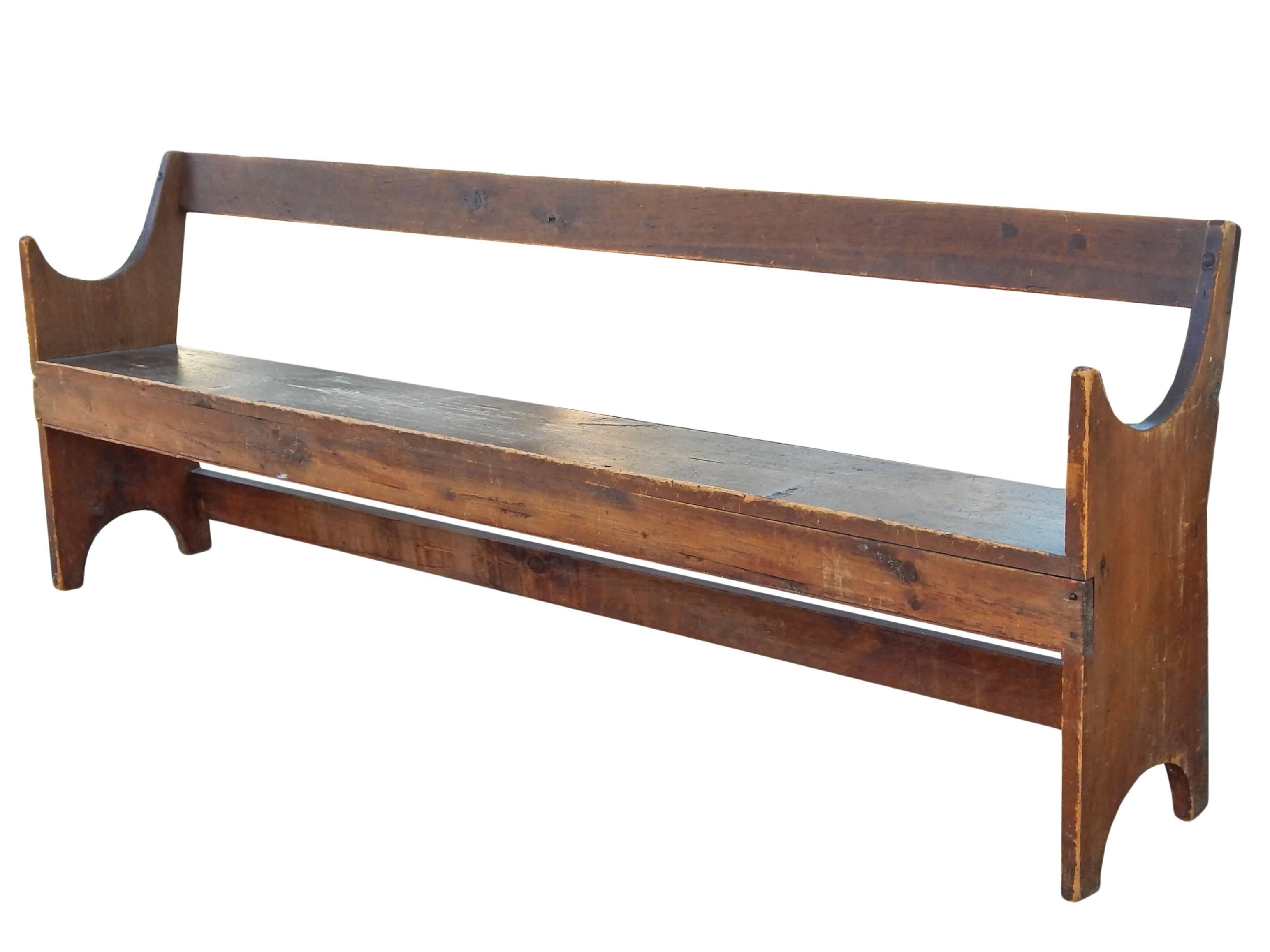Unusual curved arm wooden bench with great age patina.