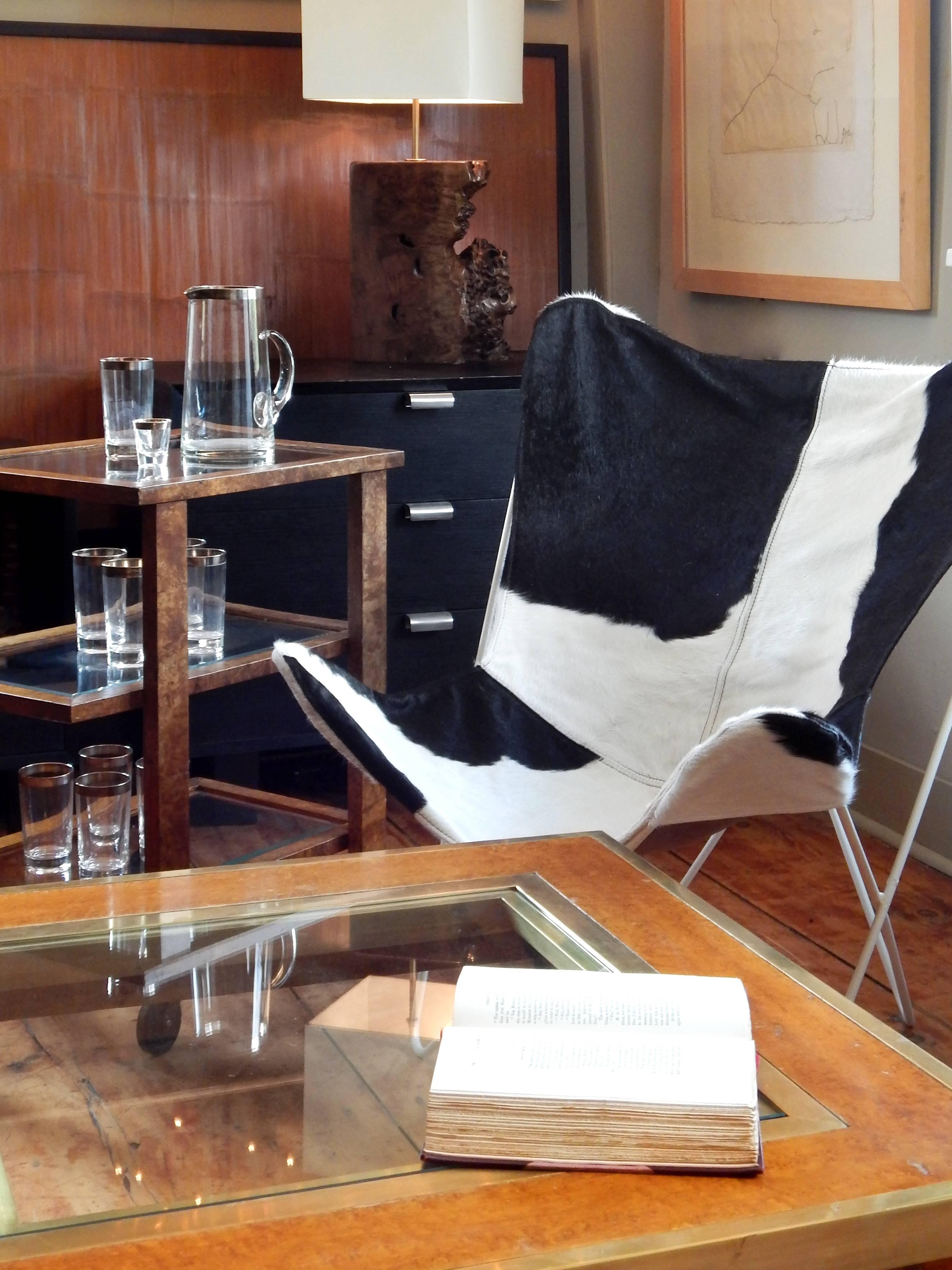 Pair of cowhide butterfly chairs with original white frames.
 