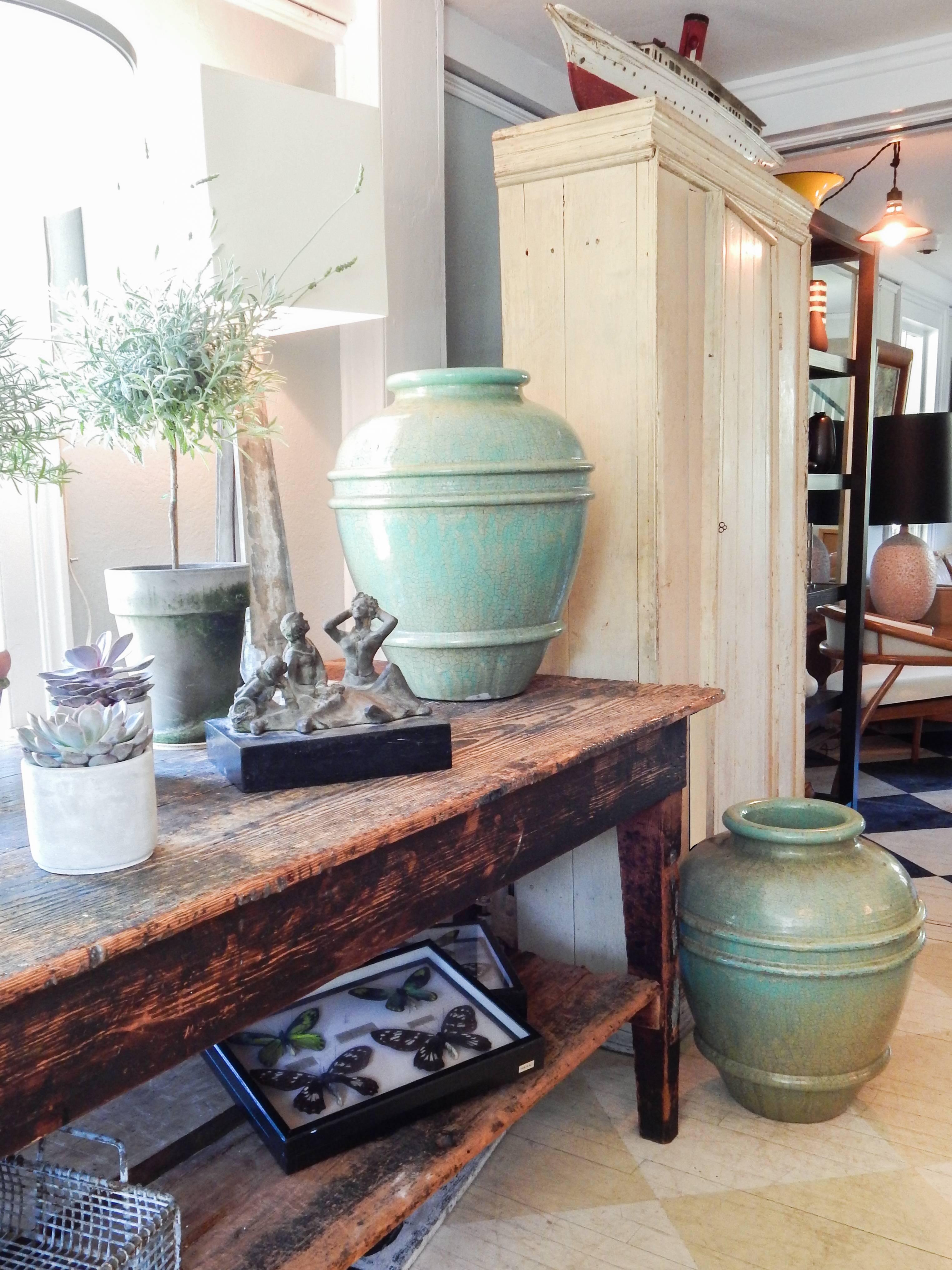 Pair of large urn planters with a crackle glaze in tones of green in the manner of Galloway.