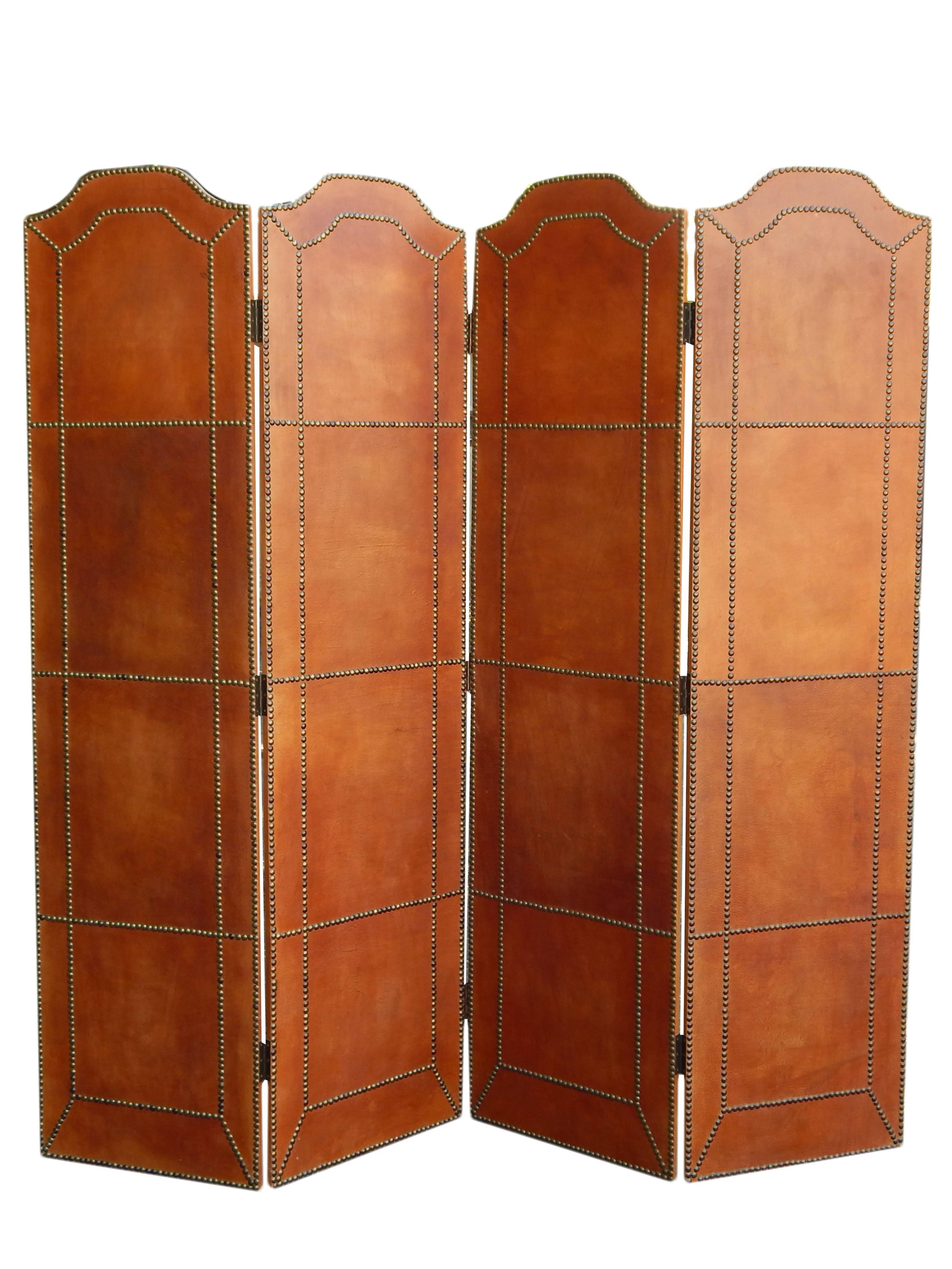Four part folding screen in caramel pigskin with brass tacks. Screen is in excellent shape with only a few tacks having some tarnish.
Each panel is 18 inches wide.