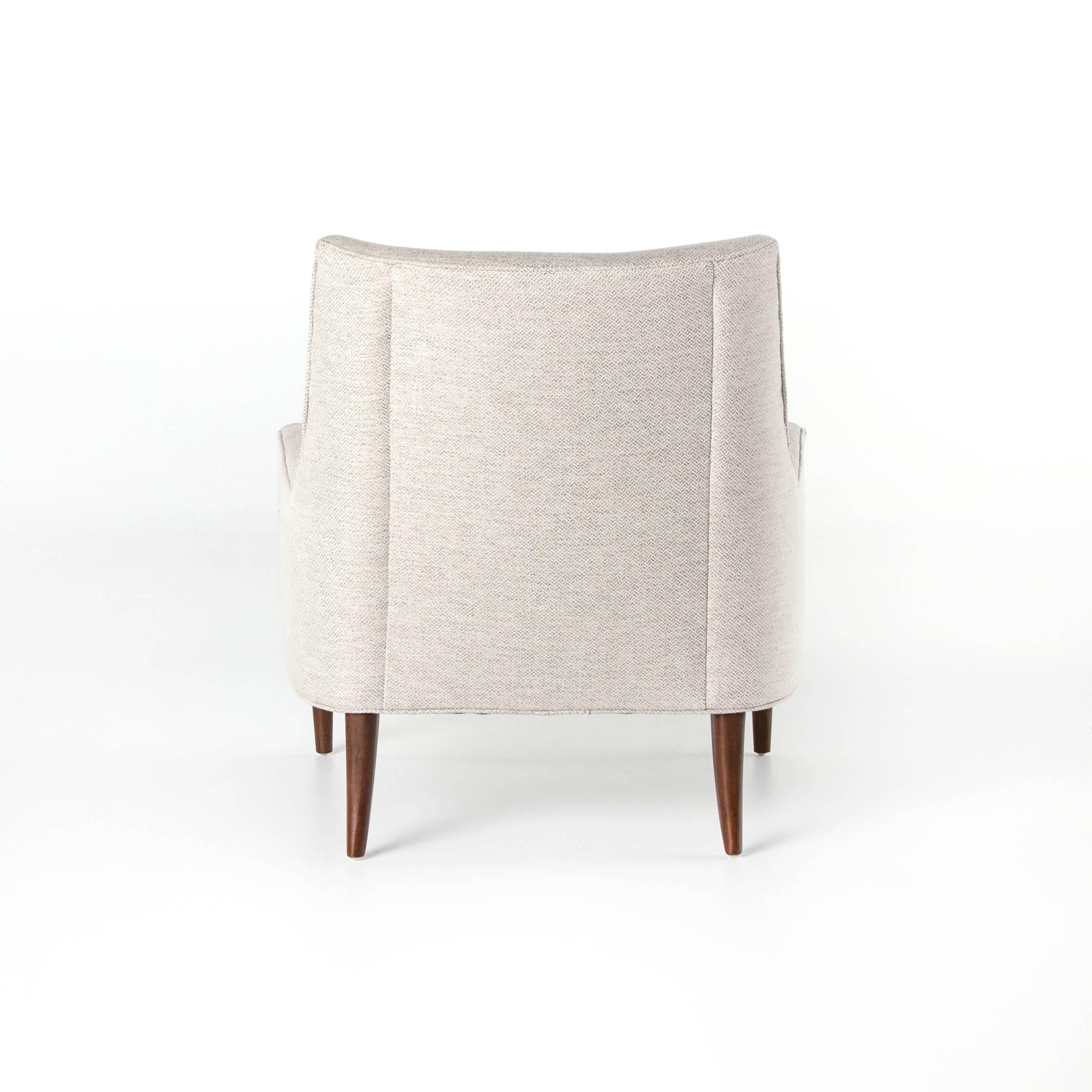 Mid-Century shaping offers comfortably molded curves to the wing chair. Crisp, neutral fabric adds a textural, woven feel paired with classically tapered legs.
Also available in leather.